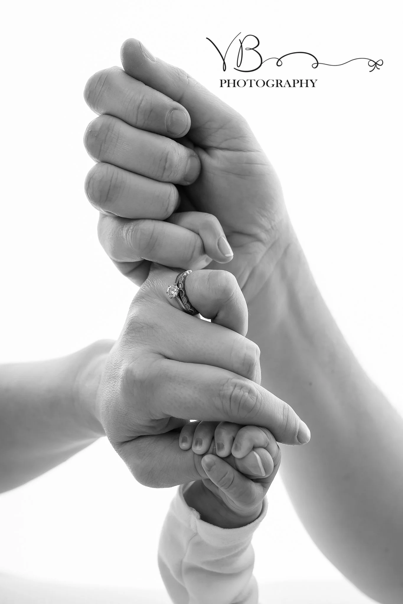Newborn Baby hand holding with parents, close up detail image of newborn baby colchester