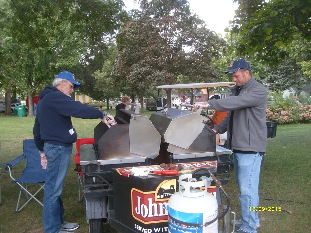 Volunteers cooking brats at the 2015 Marigold Festival