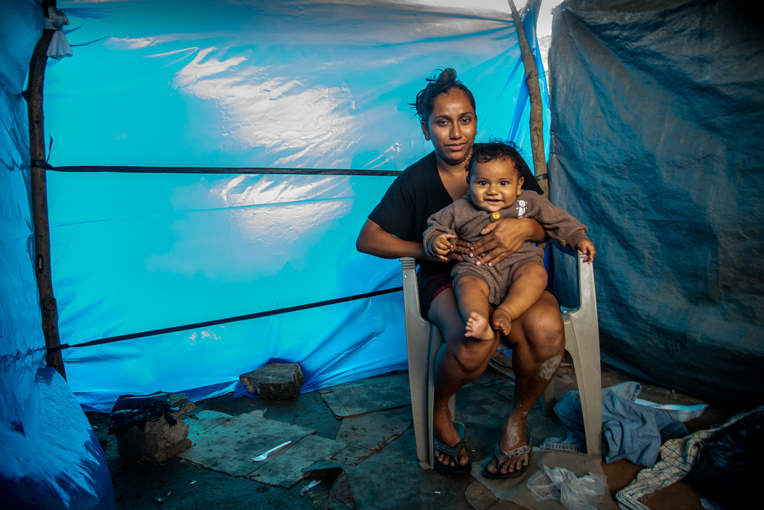  Karla Suazo, 25;  Josue, 5 months   Karla is a mother of three who was displaced after Hurricane Eta flooded her home in the community of Canaan along the Chamelecon River in San Pedro Sula. She now lives underneath an overpass, inside a three-walle