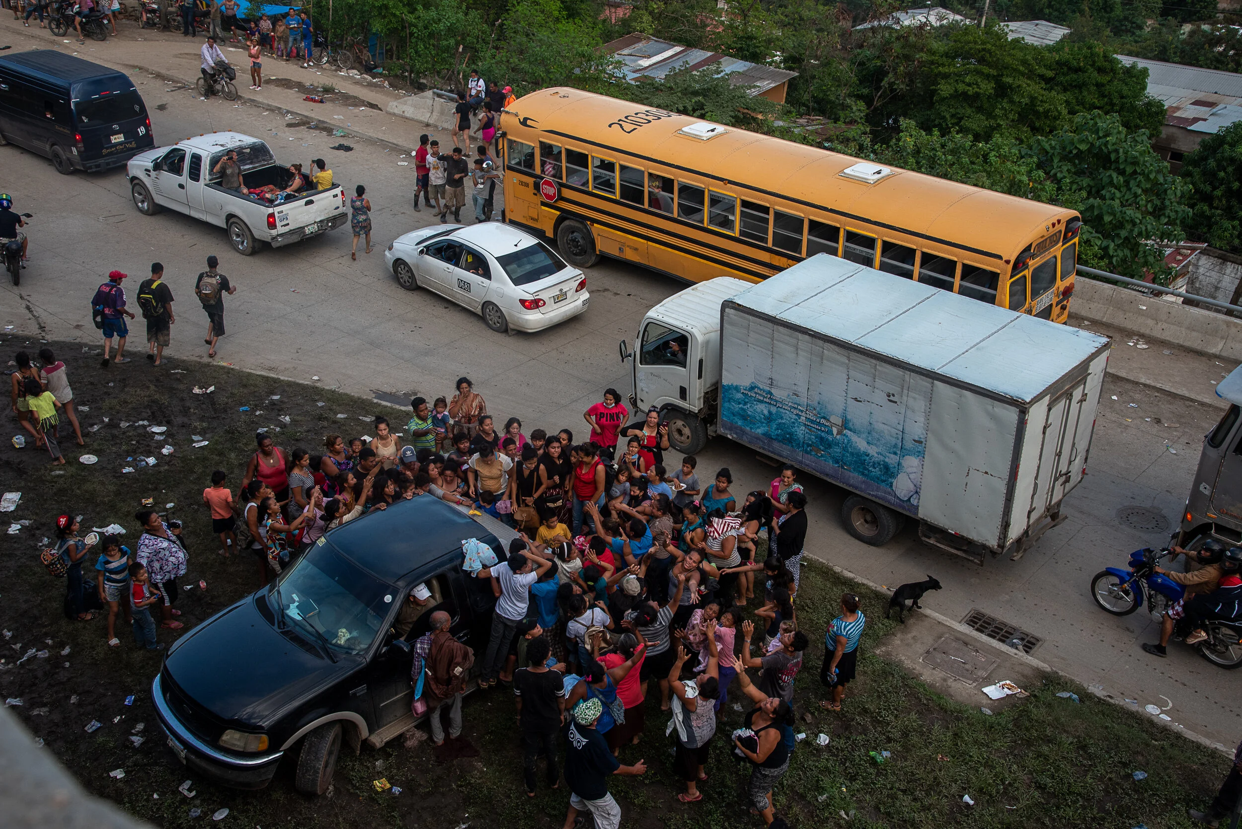  Recently displaced people in the wake of Hurricane Eta surround a truck giving out food in San Pedro Sula Honduras. In the aftermath of Hurricane Eta, hundreds of thousands of people have been displaced due to flooding. 