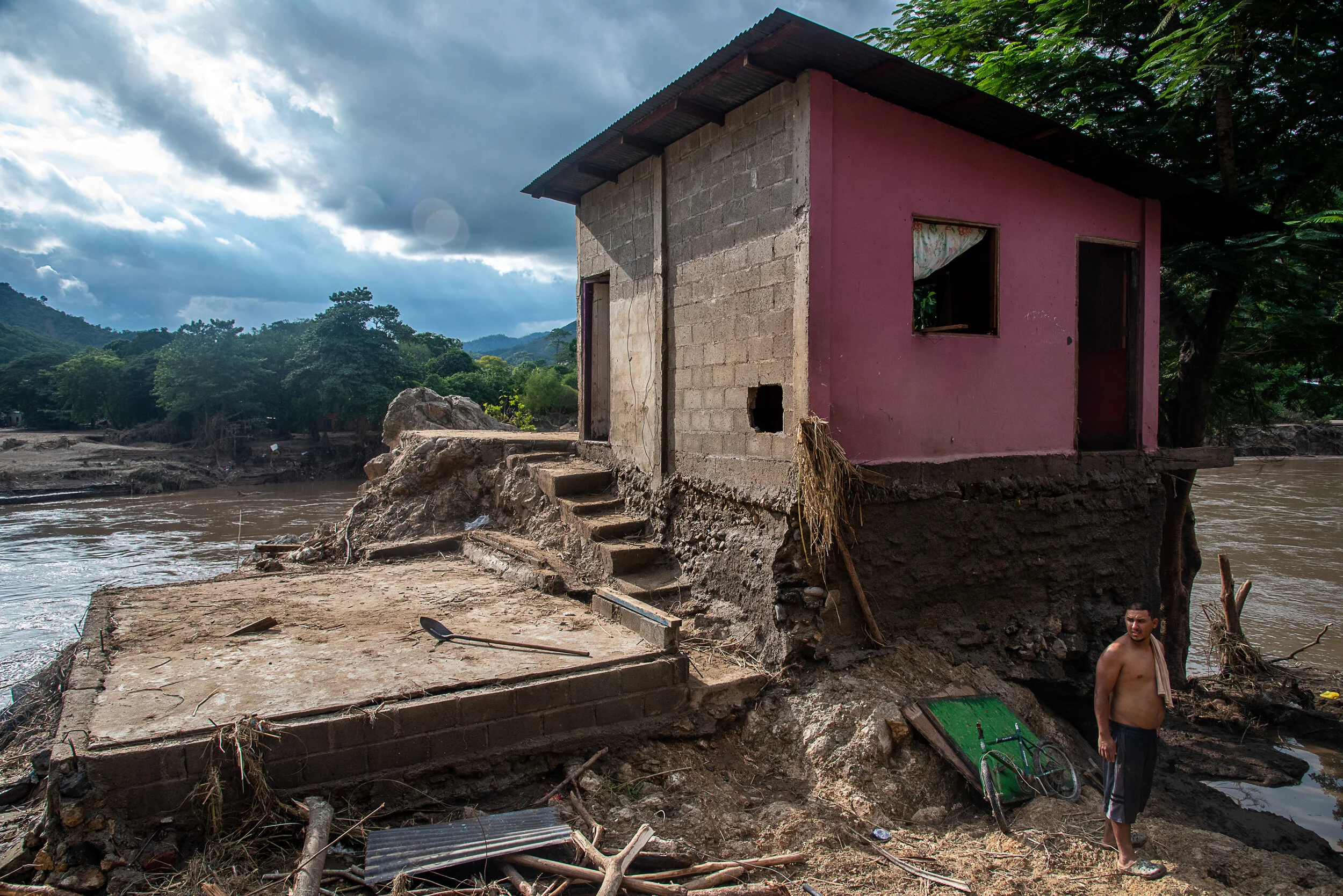  A man in front of his home that was destroyed when the Chemelecon River flooded in San Pedro Sula, Honduras. In the aftermath of Hurricane Eta, hundreds of thousands of people have been displaced due to flooding. 
