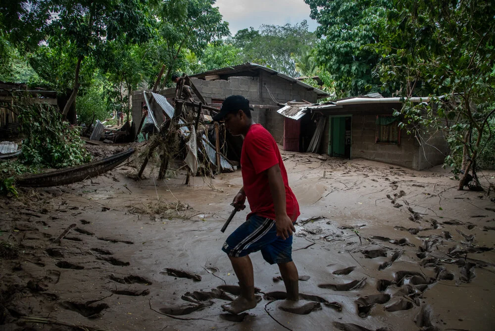  A man walks through the mud in San Pedro Sula, Honduras after his home was destroyed when the Chemelecon River flooded in the wake of Hurricane Eta. Flooding in the aftermath of Hurricane Eta has displaced hundreds of thousands in Honduras. There ar