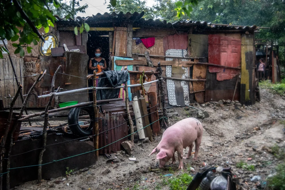  A woman outside her home while downpours from Hurricane Eta threaten to overflow the adjacent tiver and sweep her home away in San Pedro Sula. The aftermath of Hurricane Eta brings enormous amounts of rainfall which will cause deadly flooding and mu