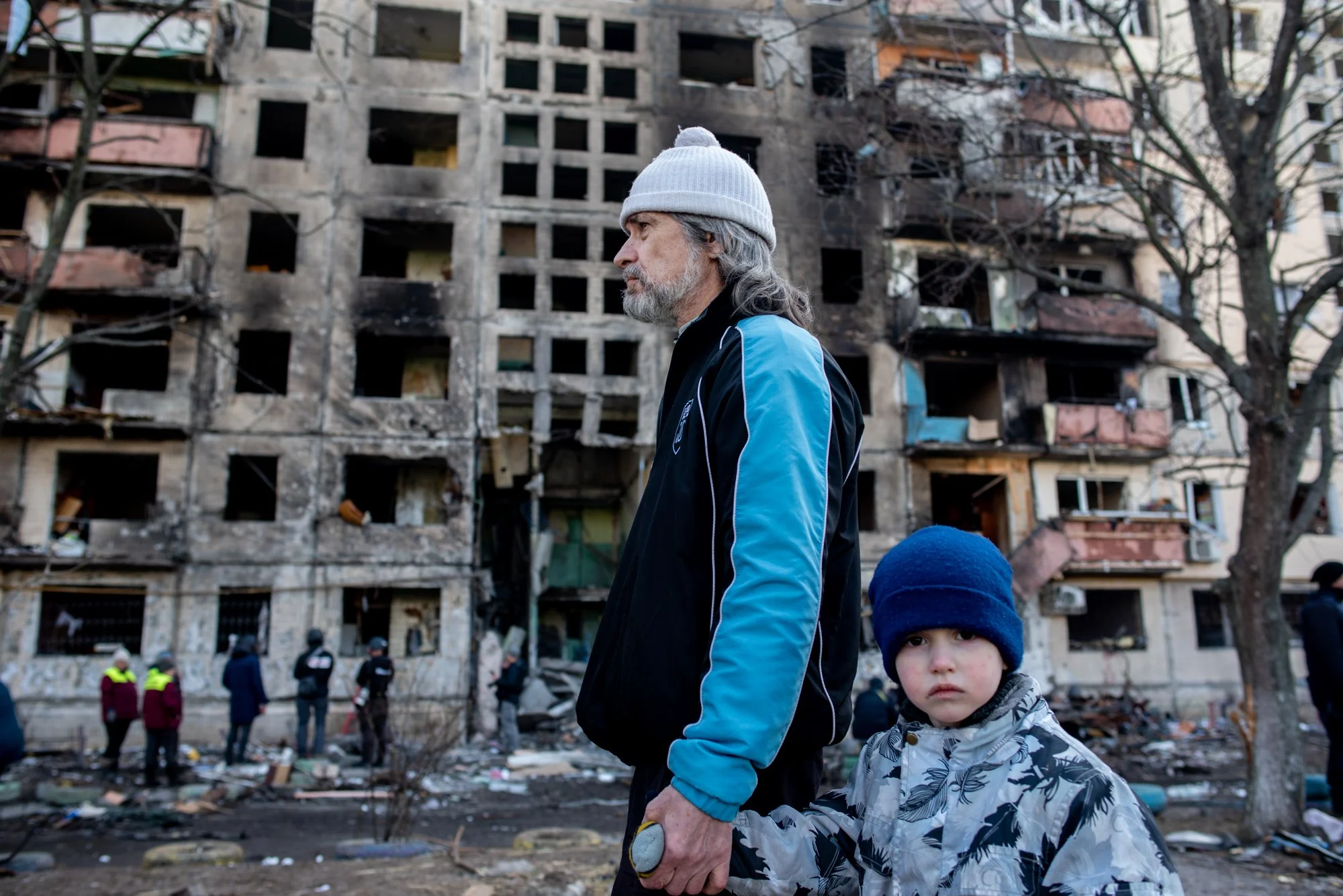  A father and son walk past an residencial apartment destroyed by a Russian air strike in Kyiv, Ukraine. March, 13, 2022. 