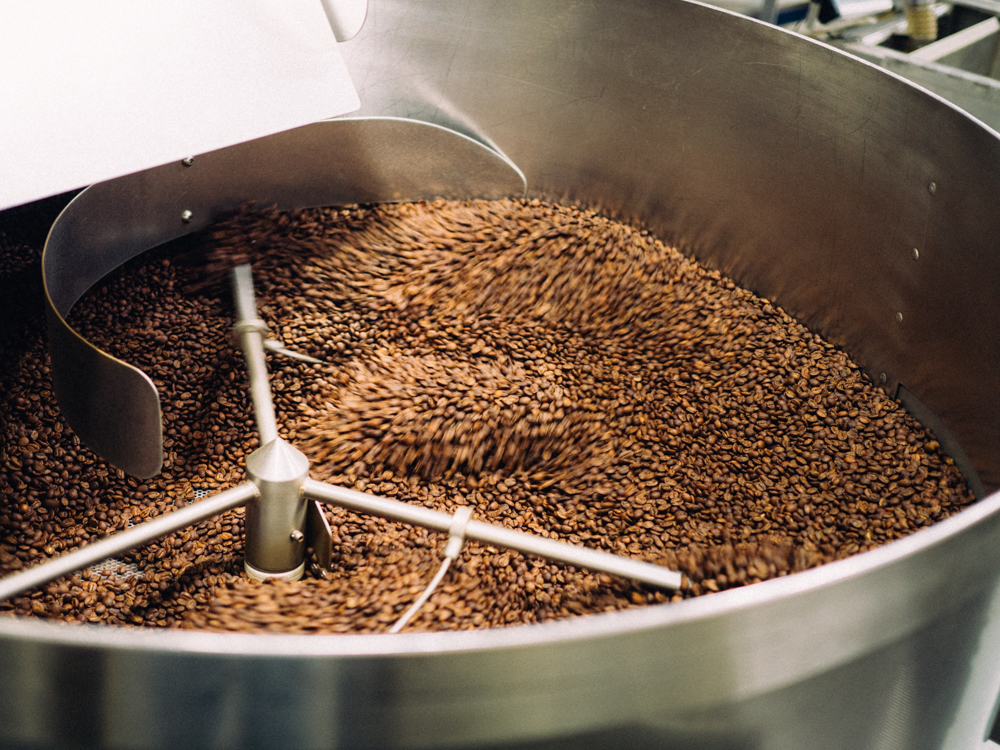  Beans are removed from the roaster and stirred to help the cooling process.&nbsp; 