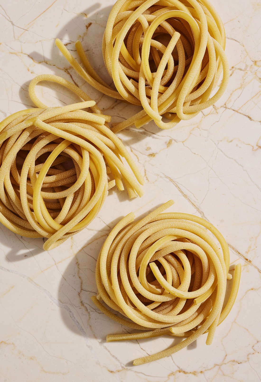 pop-of-flavor-dried-bucatini-pasta-nests-marble.jpg