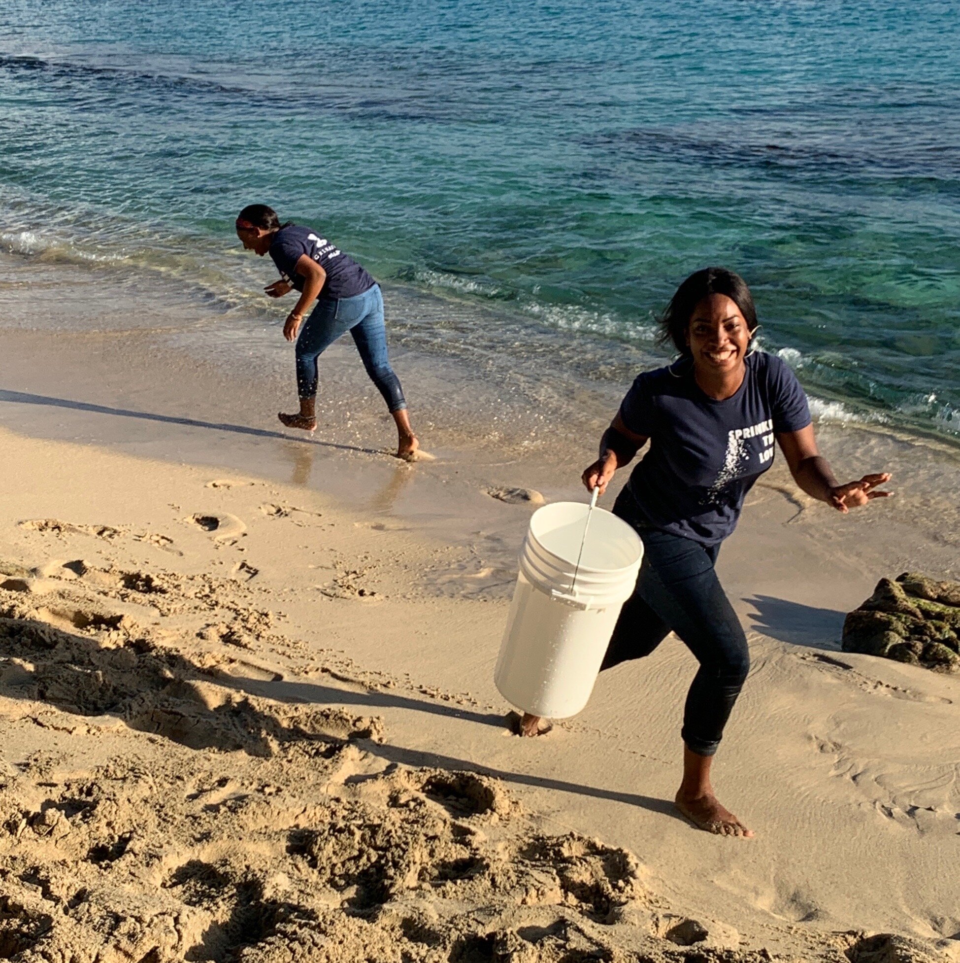 Staff happily collecting salt water at the beach
