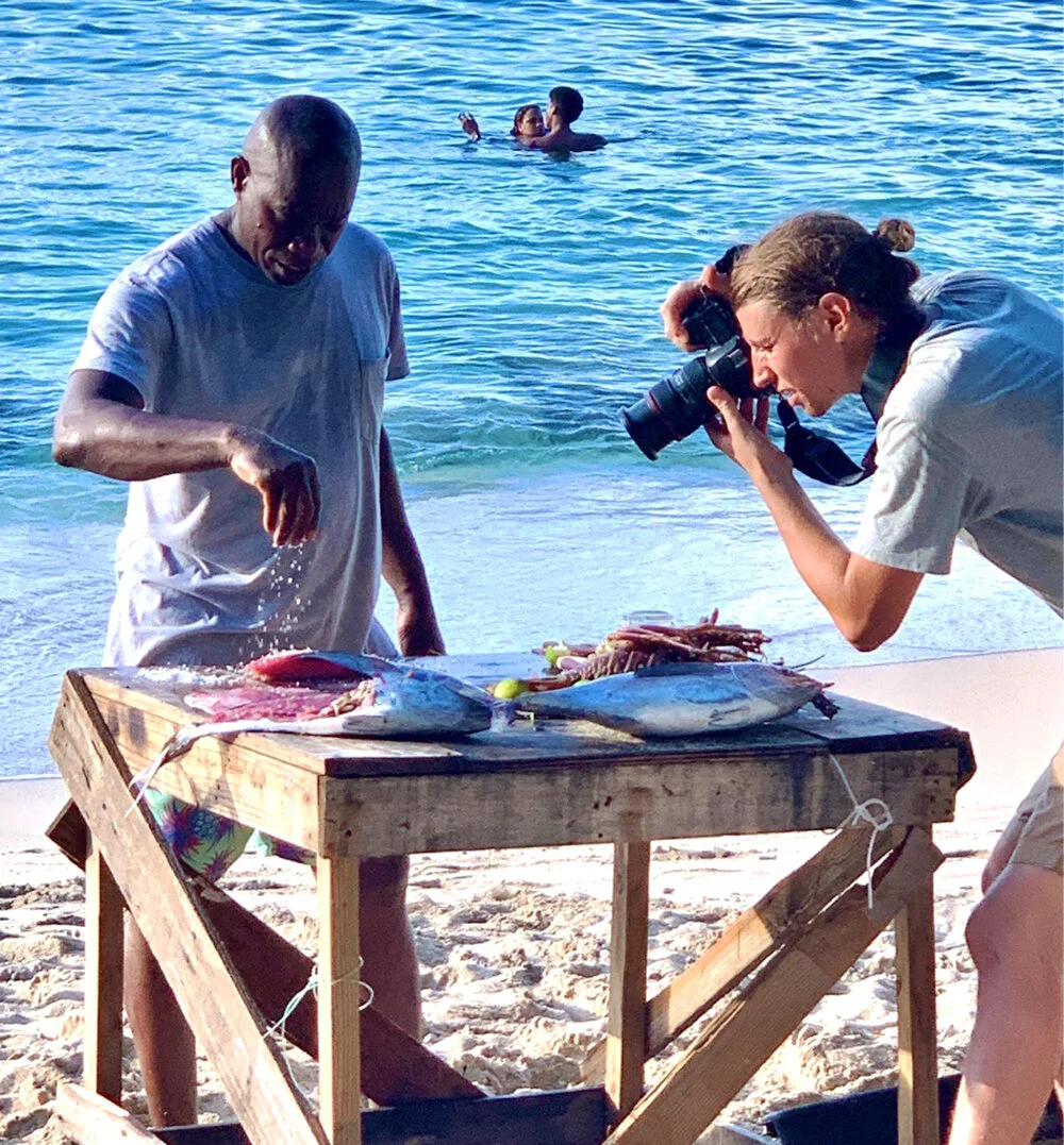Fresh caught fish being seasoned with salt