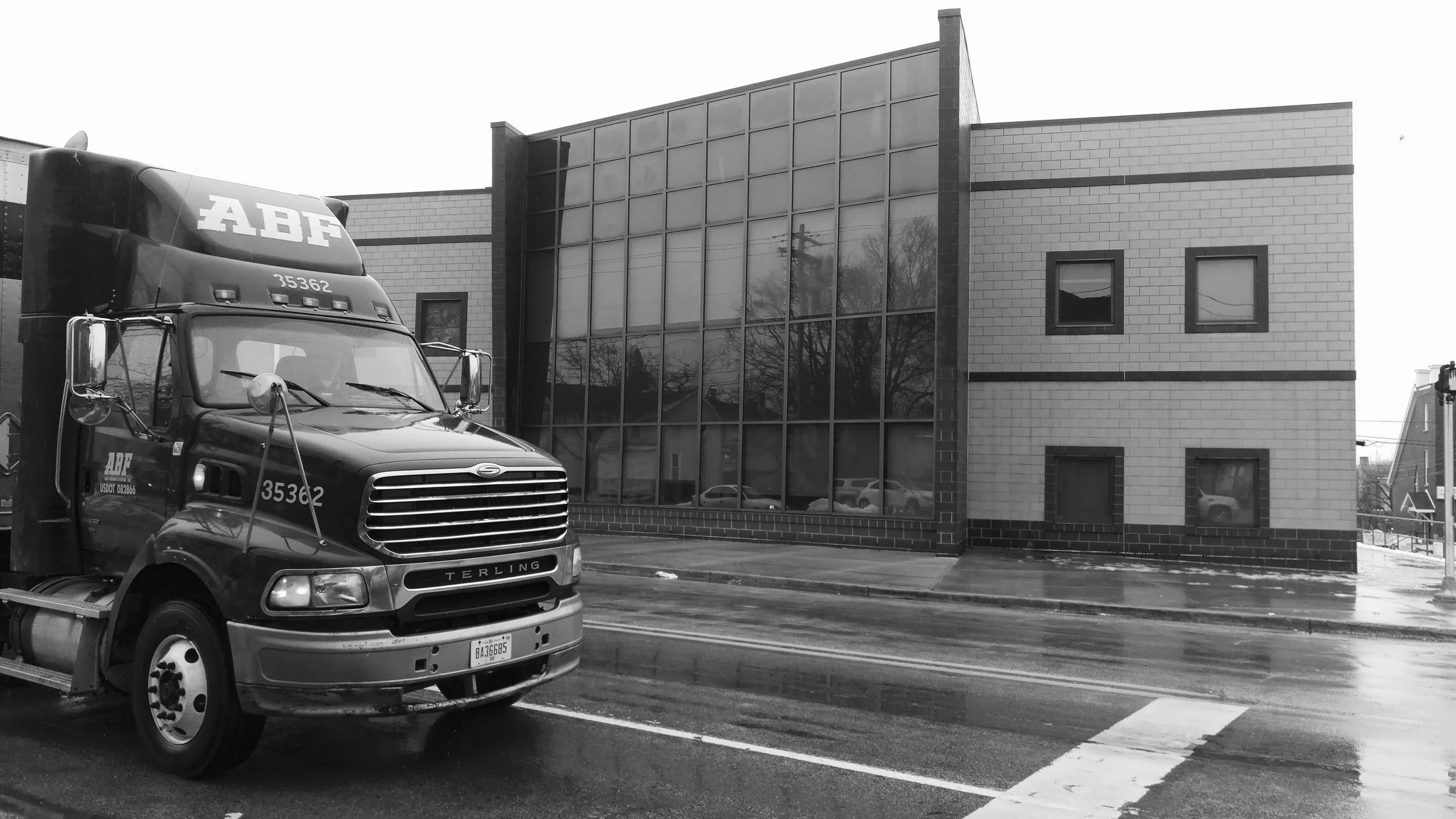 A semi truck drives along Grandville Ave. next to Cesar Chavez Elementary School. 