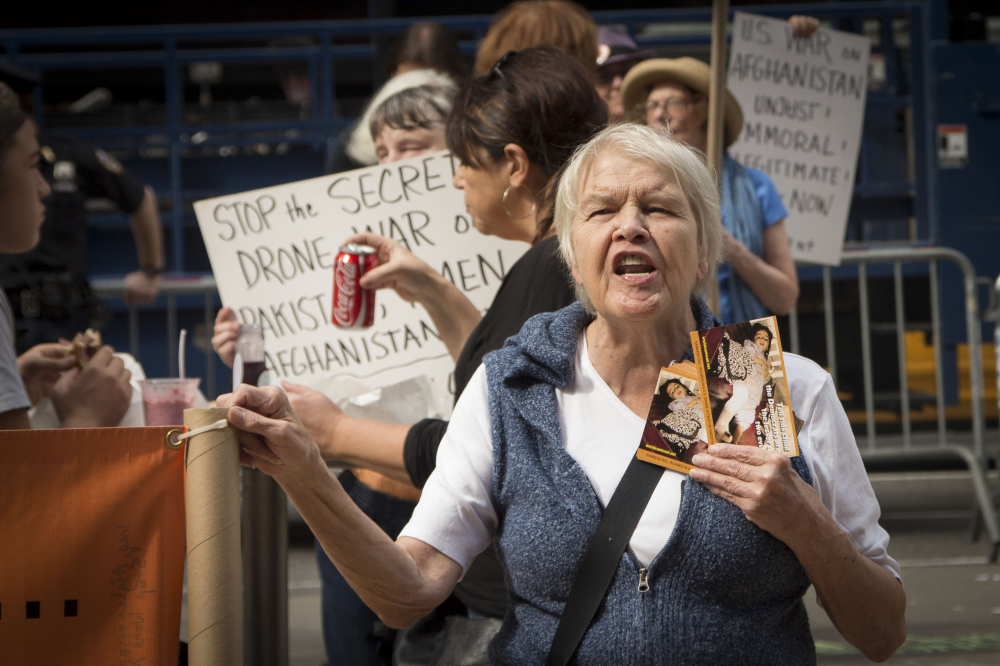 Oct. 6, 2012: Sharon, a member of the "World Can't Wait" activism group, protests outside the military recruitment office in Times Square, New York. 