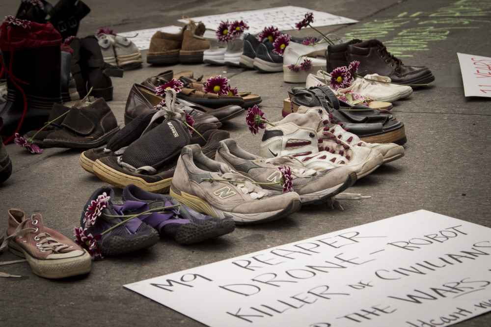  Oct. 6, 2012: The "World Can't Wait" protest group hold a memorial of shoes for the civilians killed in the Iraq and Afghanistan wars in Times Square.&nbsp; 