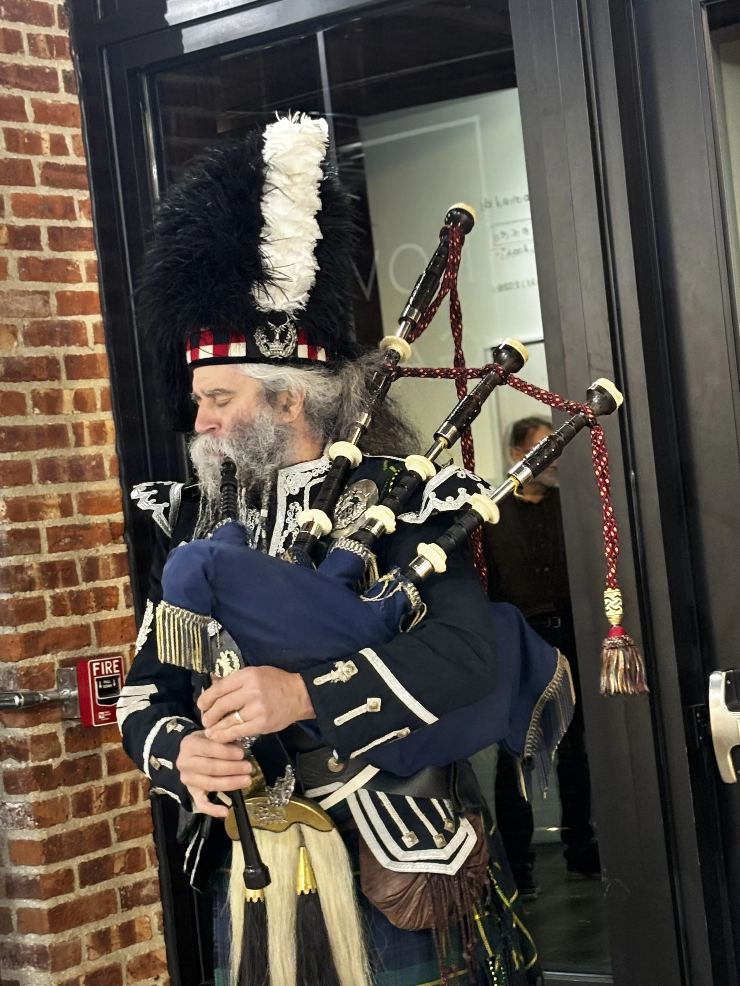 Jerry Dixon - Celtic Bagpiper at Novado Gallery, during "Transference, Torridon & Wester Ross"  opening exhibition by Susan MacDonald