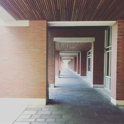 Walking past some classrooms near the campus commons outside