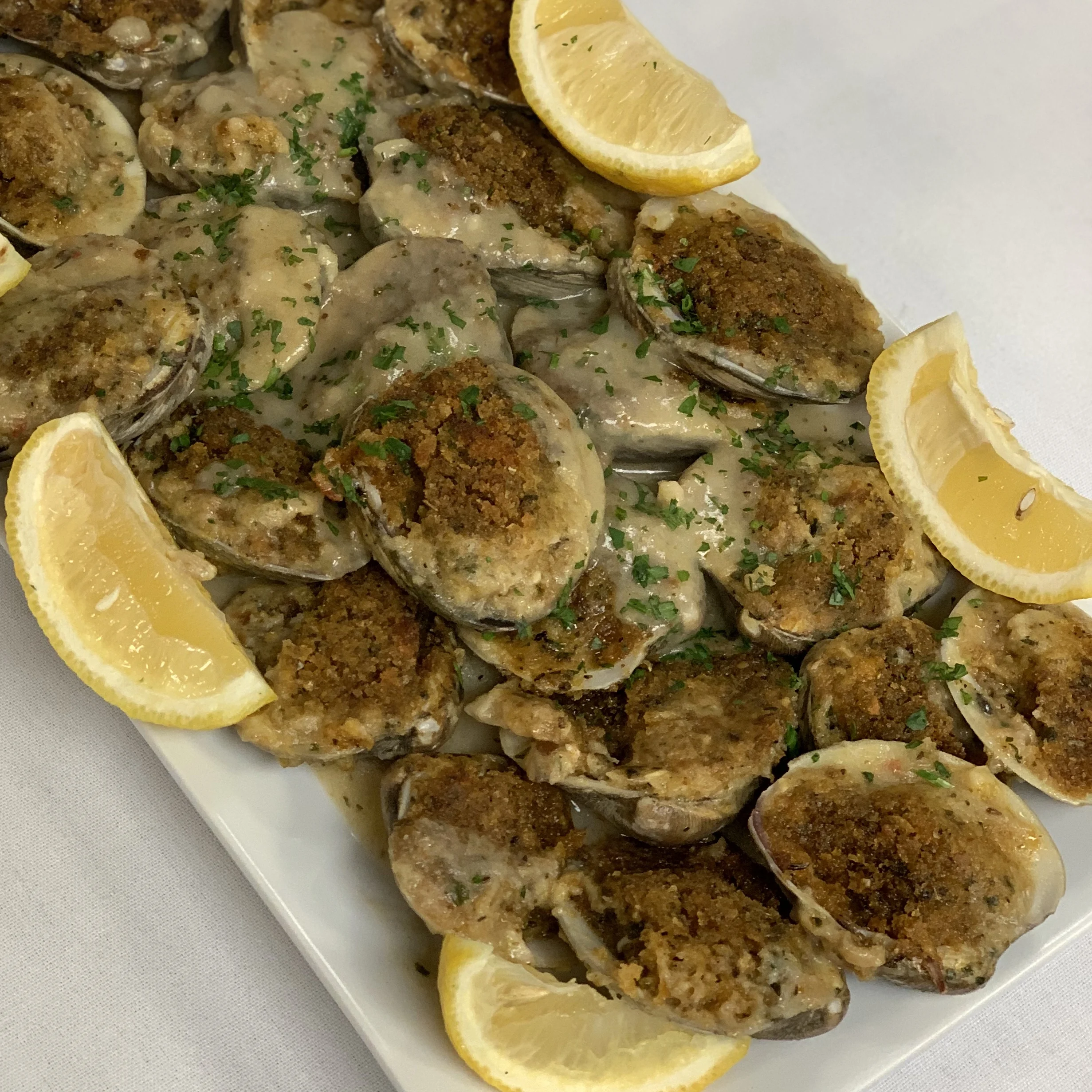 Clams oreganata, featuring Pop’s famous Italian breadcrumb, cheese and white wine mixture as the topping!