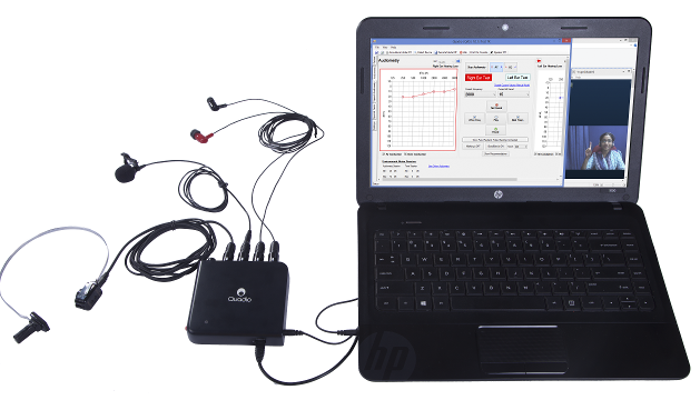 Quadiometry setup with a laptop and a Quadio audiometer (Quadiometer) connected to the laptop as well as a bone conductor, headphones and microphone