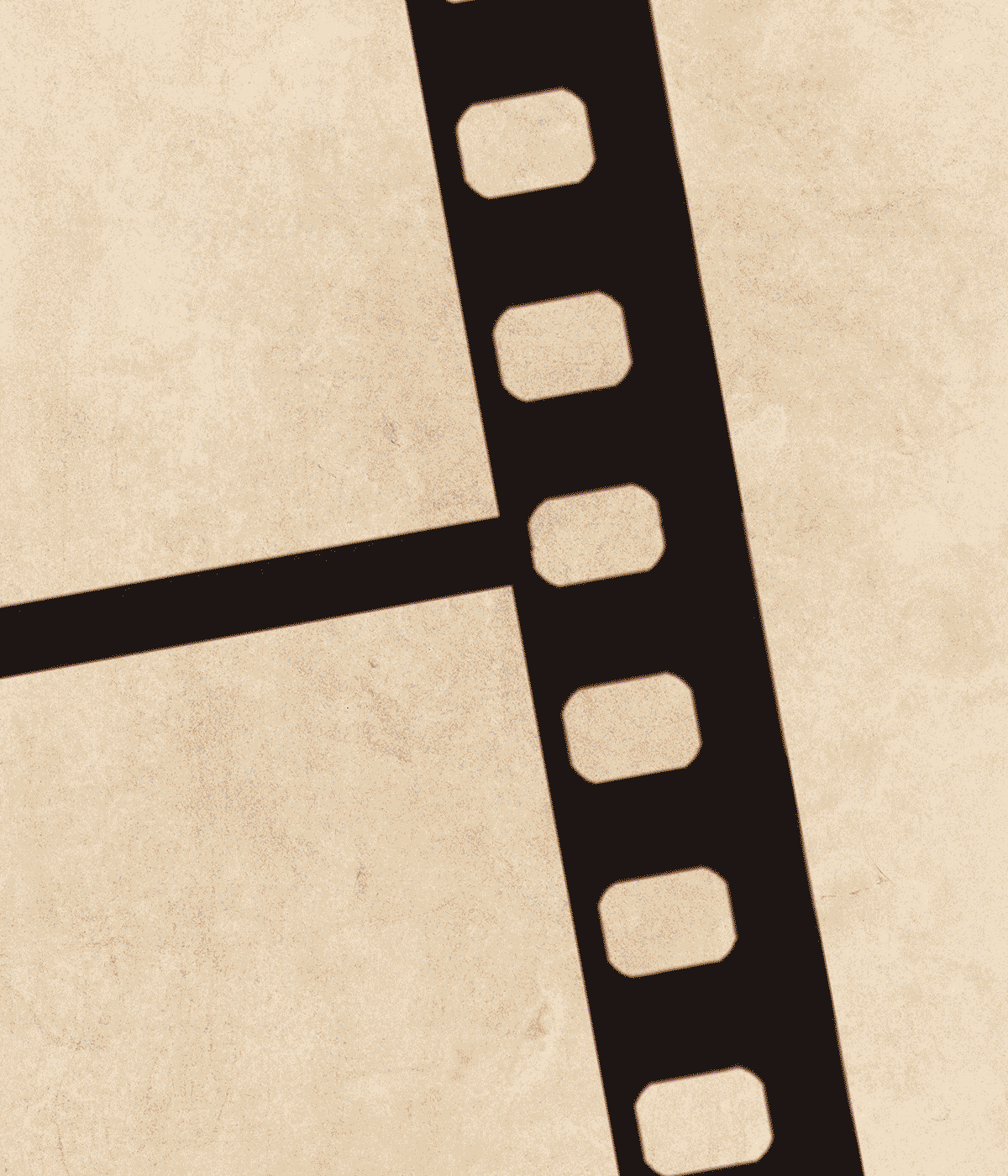 Close-up of a black film negative strip on a beige background showing horror movie themed tees.