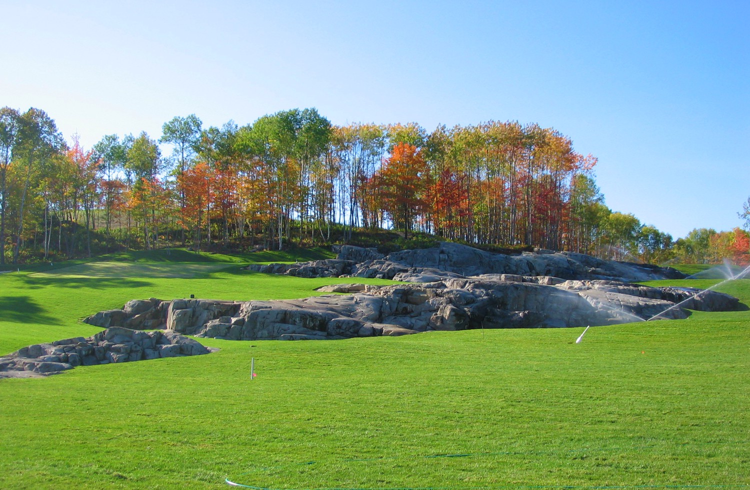 Frog’s Breath Golf Course, New Liskeard, Ontario Located in a remote corner of Northern Ontario, Frog’s Breath is a golf course that few people will ever hear about and fewer still will have an opportunity to play, because it is privately owned. It may also be one of the most challenging and scenic nine-hole courses in Ontario. Built on a 40-acre parcel of rugged woodland behind our client’s home, Frog’s Breath presented many unique design challenges. Seven new golf holes were integrated with two remodeled holes of the previous four-hole course. The nine hole, 3,000 yard, par-33 layout features dramatic elevation changes in excess of 100 feet and is accented with two spectacular waterfalls that tumble over massive rock outcroppings. One of the biggest design challenges faced on this project included the incorporation of an eight million gallon reservoir into the compact layout, in order to minimize the requirements for water taking from the adjacent Twin Lakes.