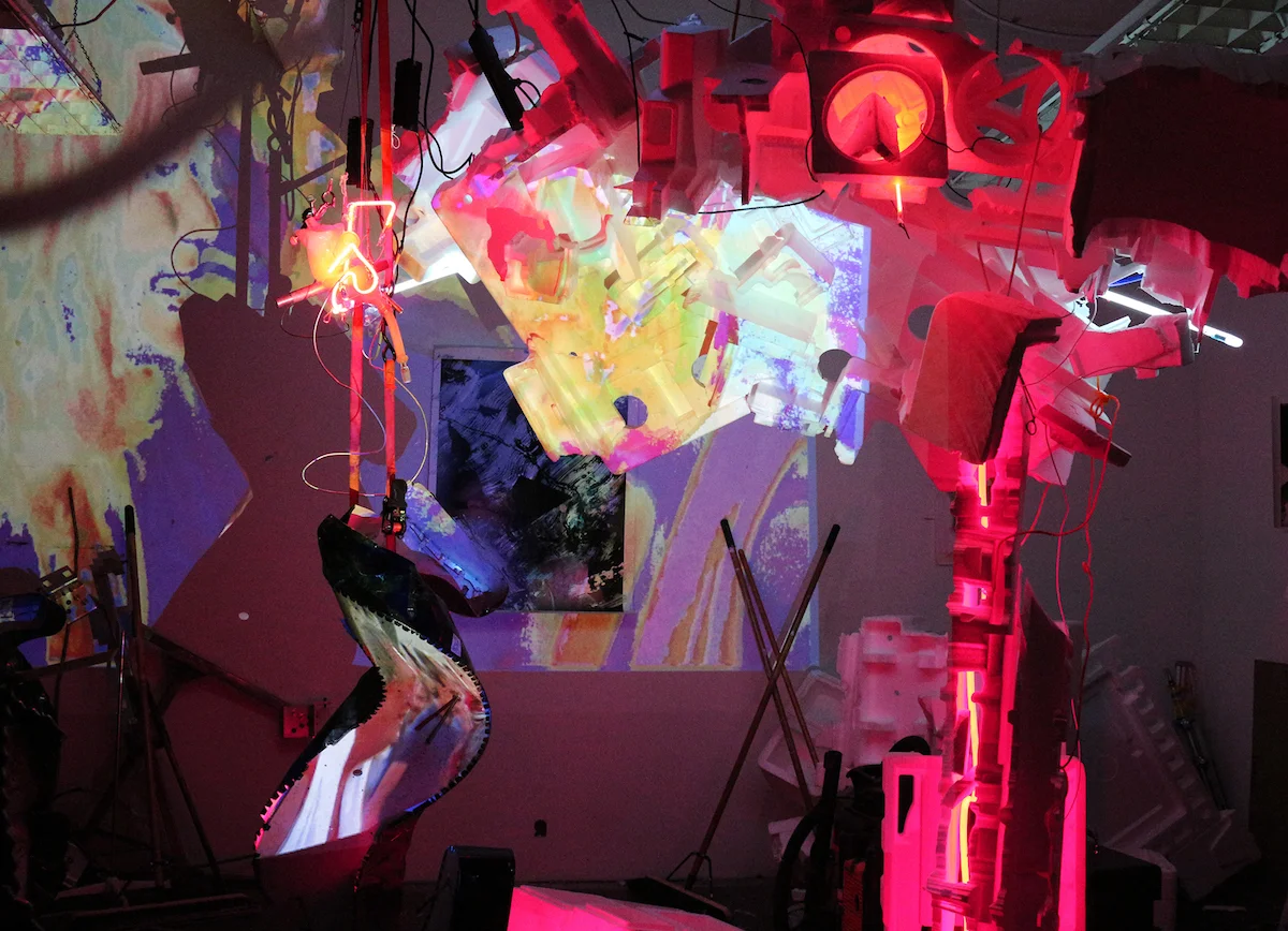 Dear Volunteers , neon, rebar, styrofoam, painted photos cast in epoxy, lab clamps, security cameras, projectors, computer, algorithmically generated interactive projection-mapped video. Collaborative installation with John Schlesinger, Fort Mason Center for the Arts, San Francisco, 3,200 square feet, 2016. https://dearvolunteers.blogspot.com/