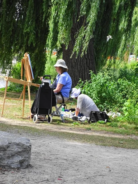 Helen in the blue shirt painting on location.