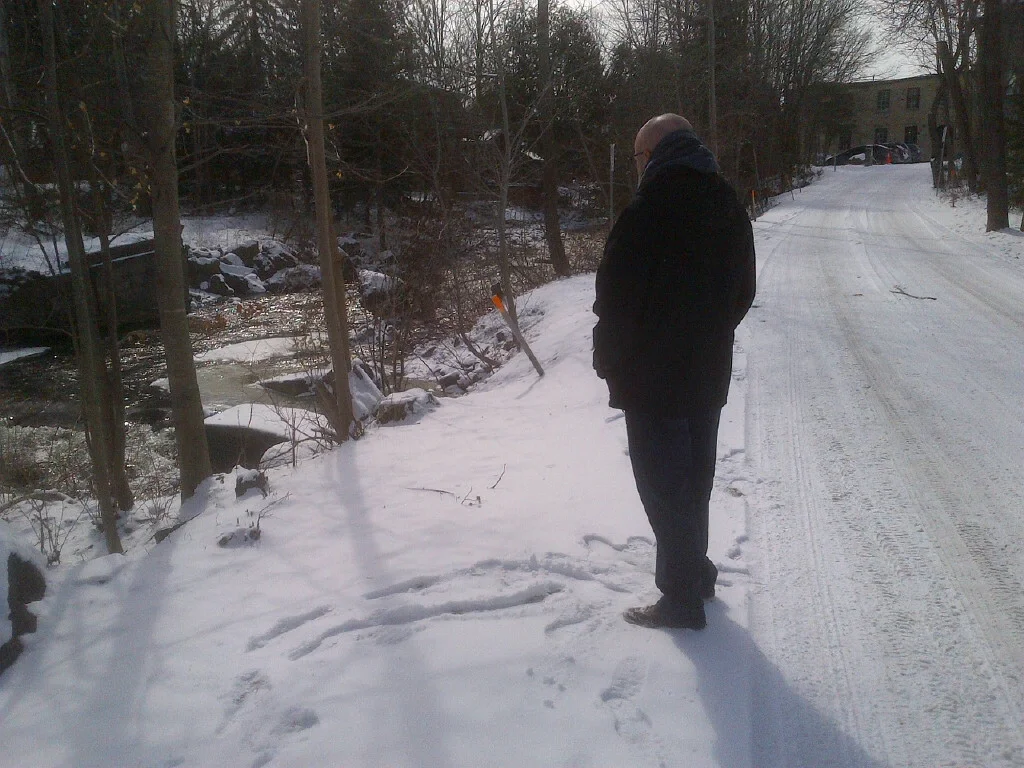 Robert taking a break from the long hours of painting. This is Shaw's Creek, and you can see the Alton Mill Arts Centre in the background.