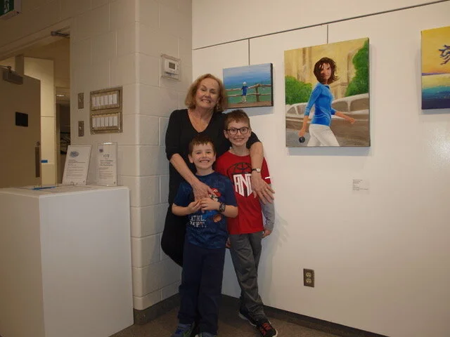 Above is artist Helen Duplassie with her grandsons who came to enjoy the exhibition at the Nielson Park Art Centre.