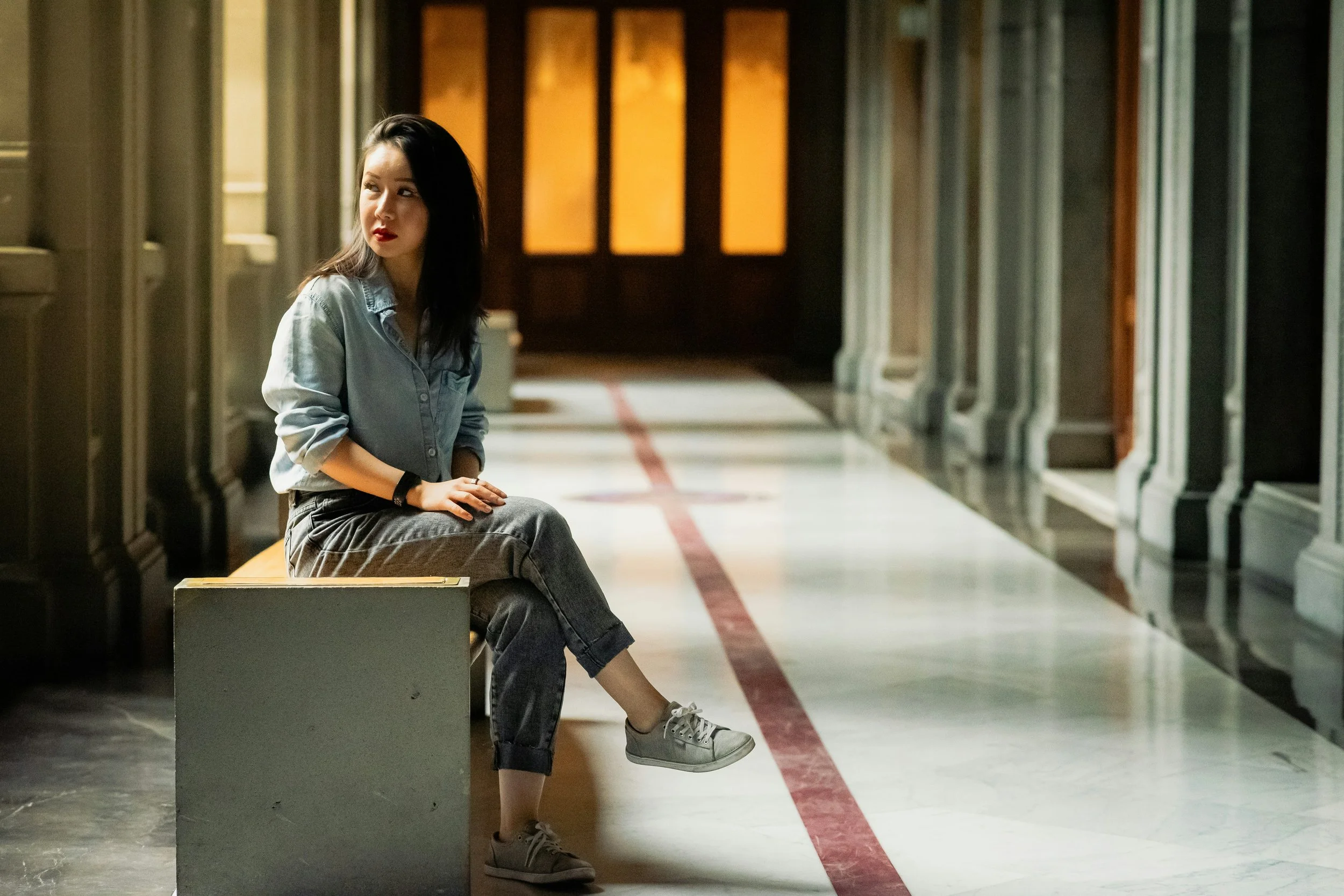 Woman alone in a courthouse sitting on a bench