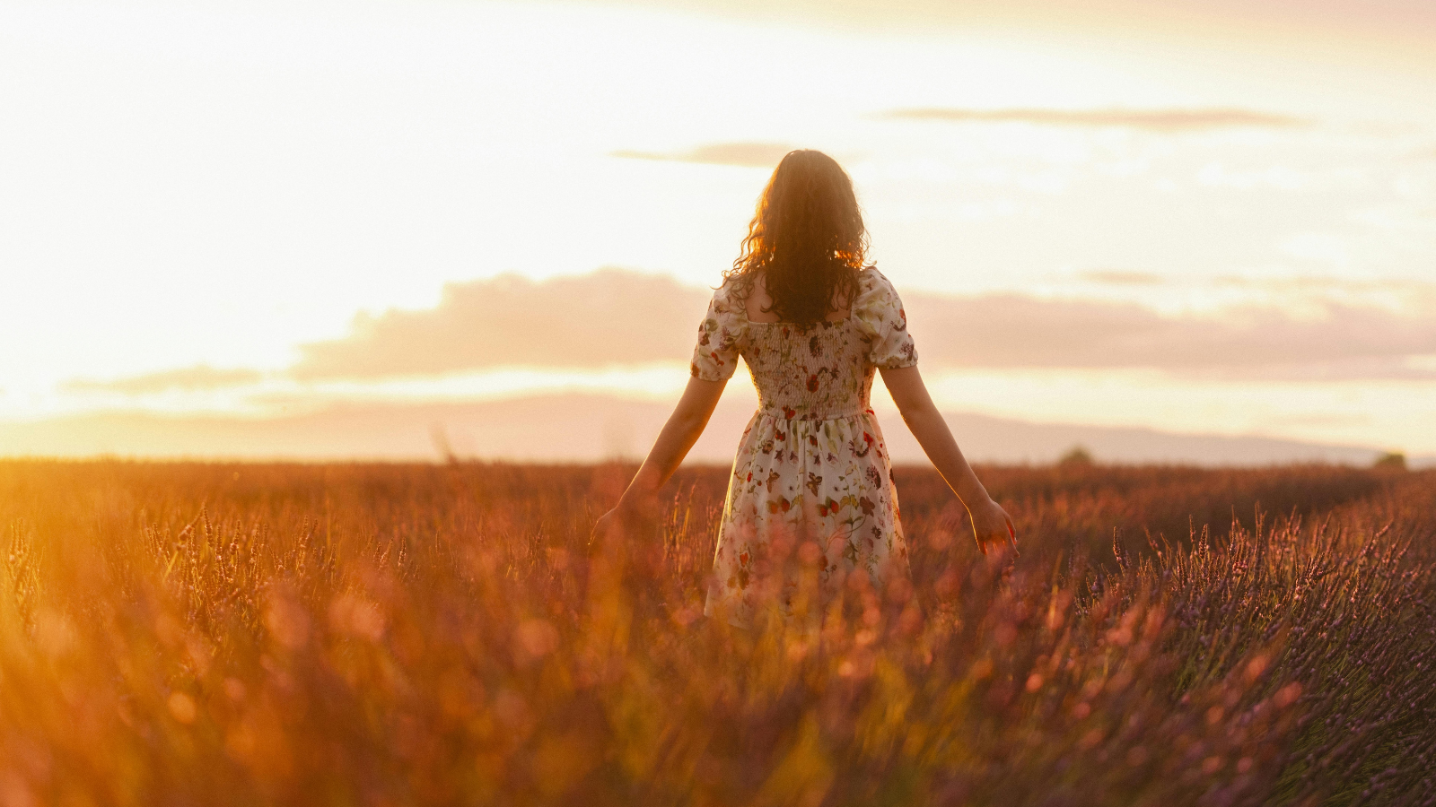 woman walking through field Nebraska divorce support.png
