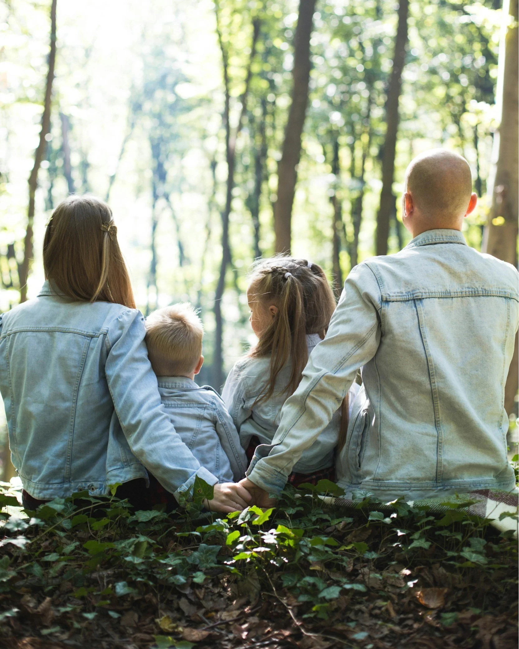 Parents with children in the woods holding hands