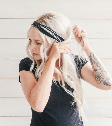 2 - leave some hair out around your face to make for a softer look. You could also pull all hair back from around your face. Find your first section of hair you would like to pull back and spin it around the headband. I would pass my piece of hair through to my other hand and pull it through making a loop around the headband.