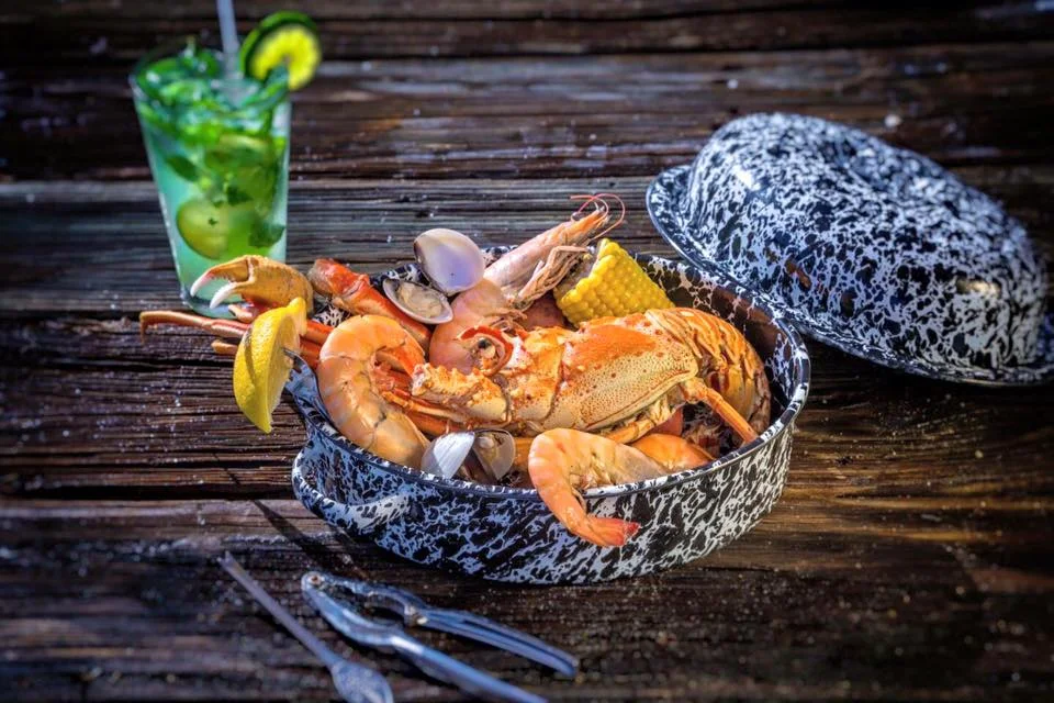 The Stoned Crab's Lobster Steamer Pot paired with an Eco-Bar cocktail