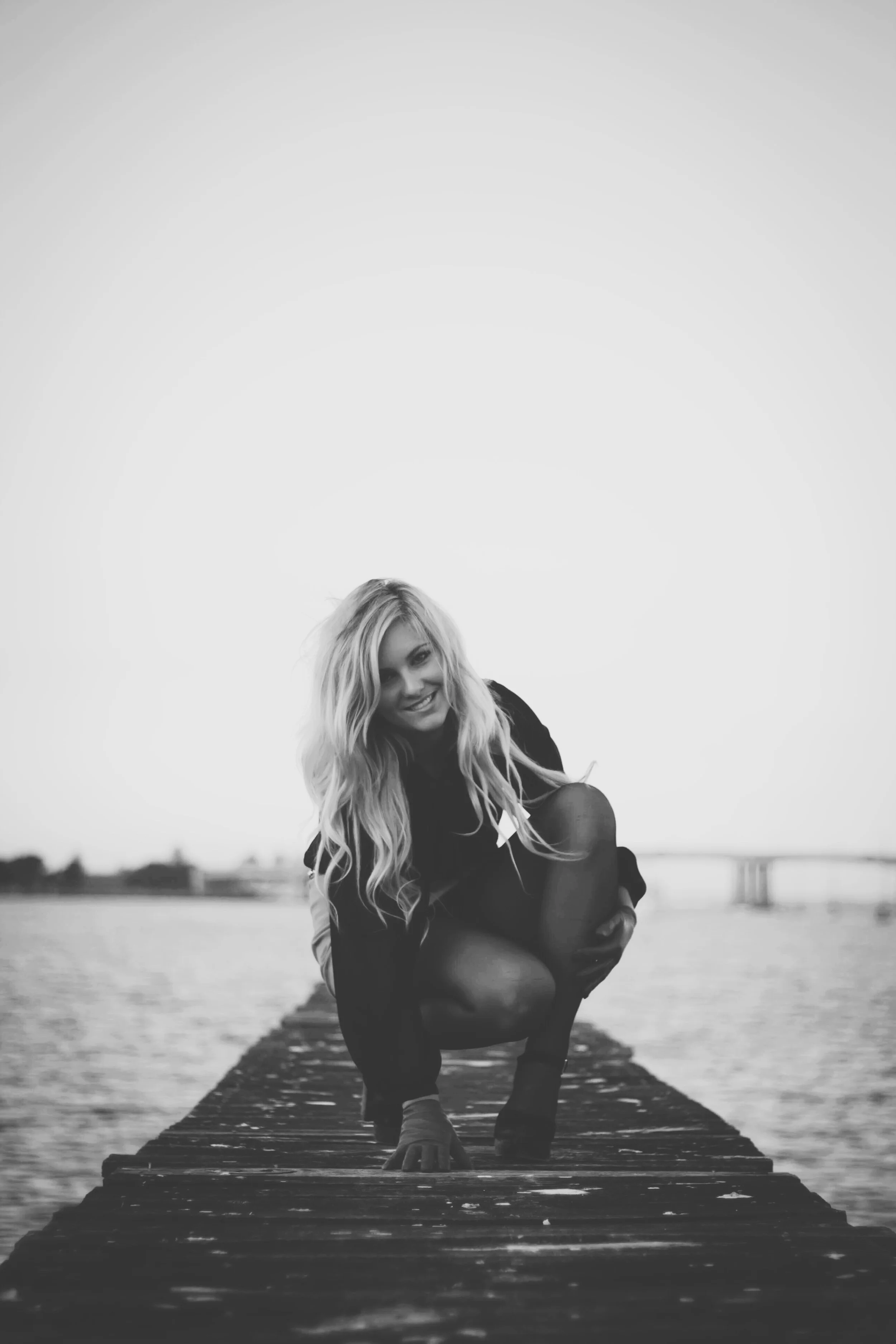 young girl sitting on wharf