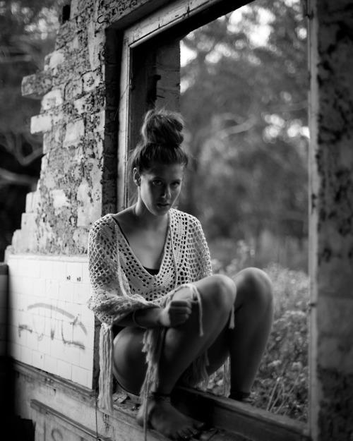 girl sitting in abandoned building 