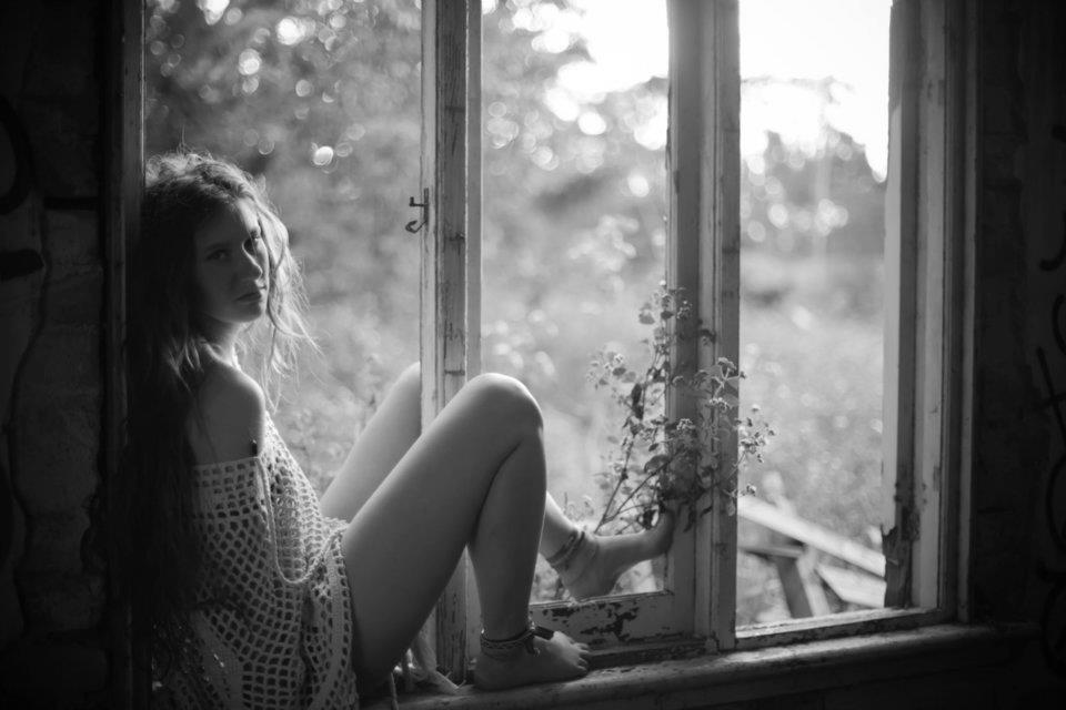 girl sitting in abandoned building 