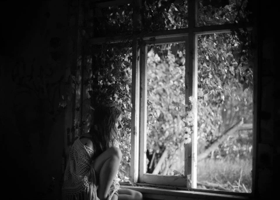 girl sitting in abandoned building 