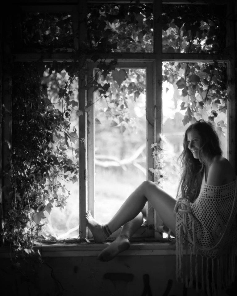 girl sitting in abandoned building 