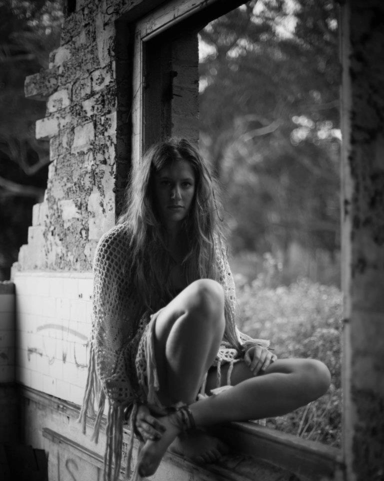 girl sitting in abandoned building 