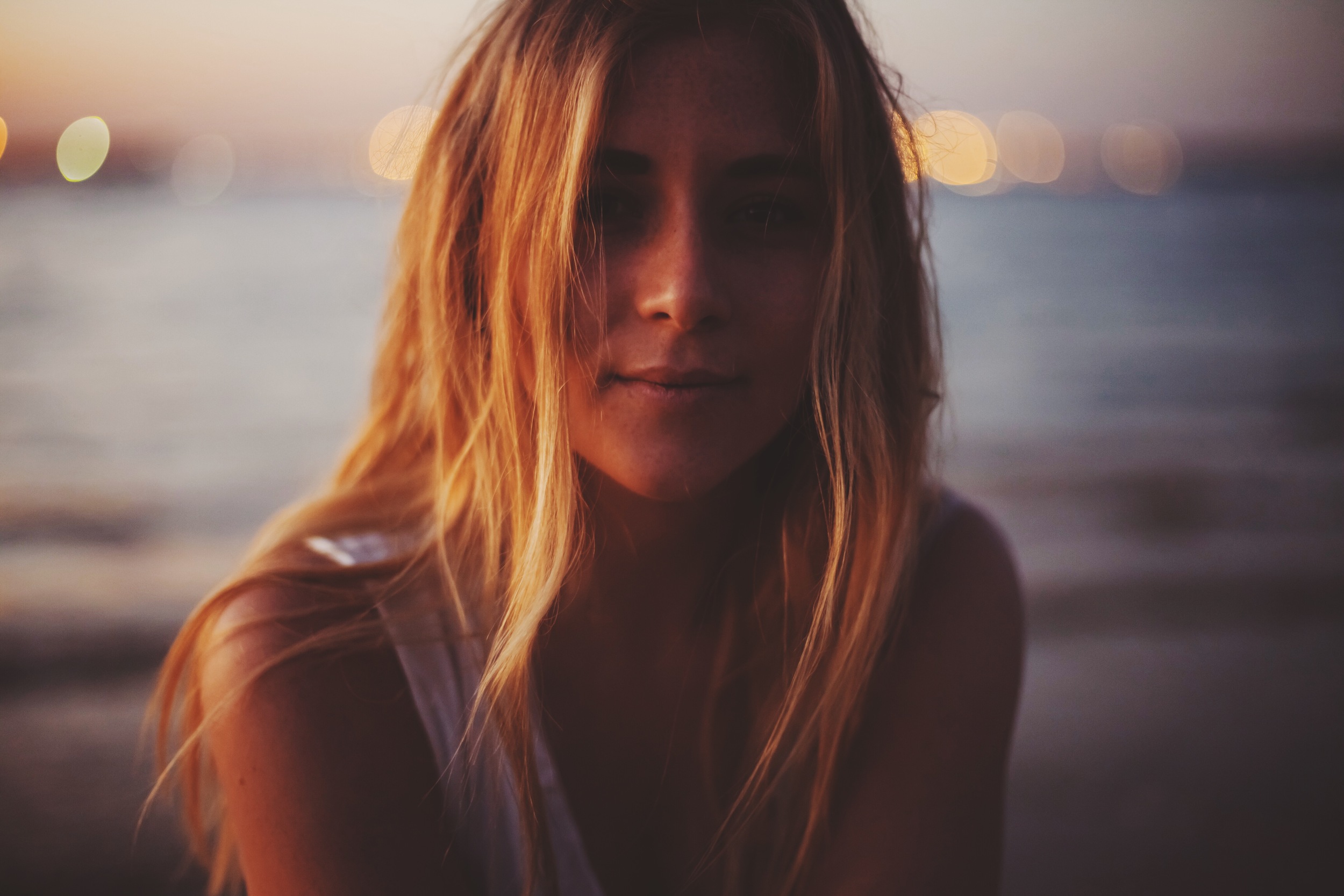 portrait of woman sitting by the sea