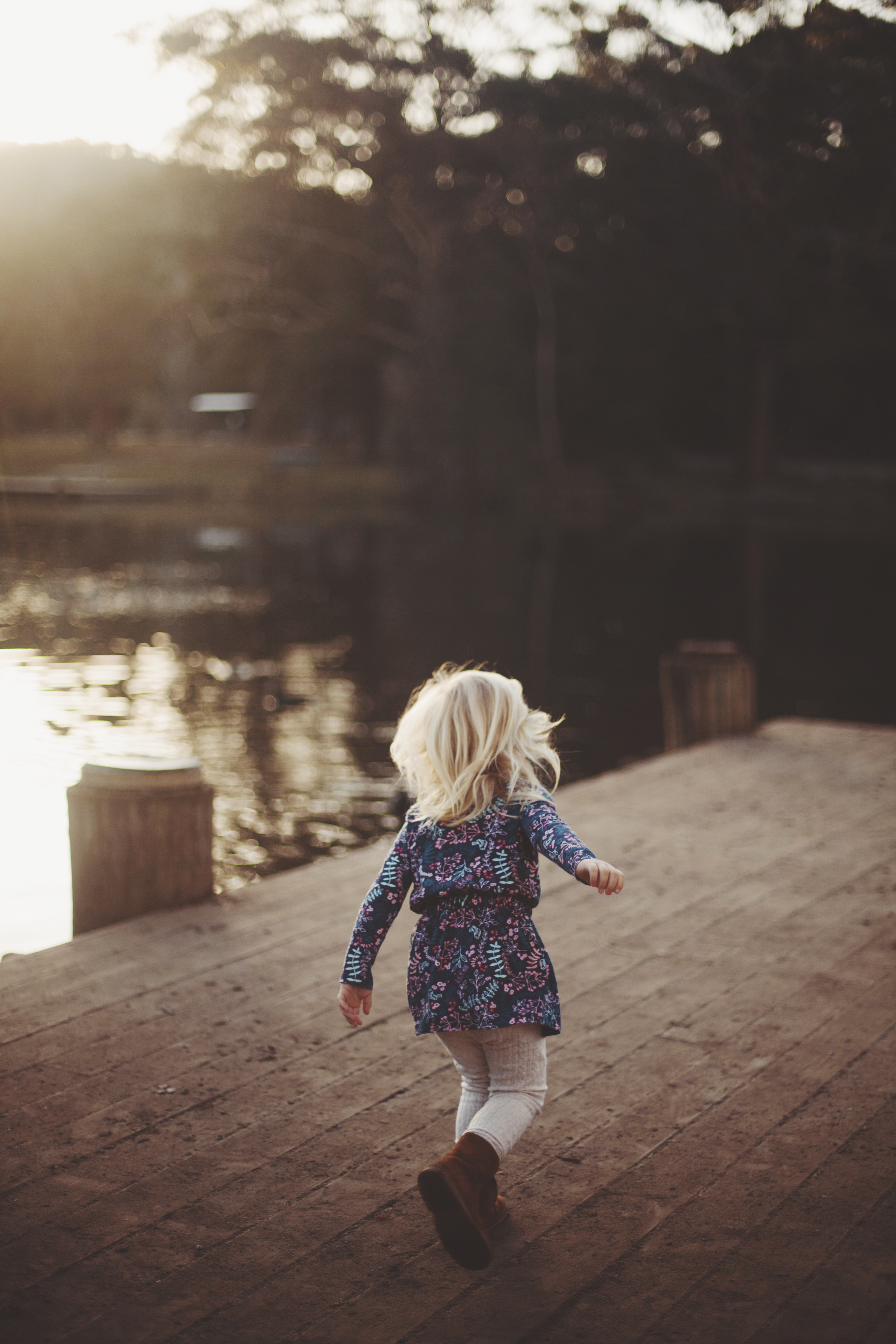 young girl running along waters edge