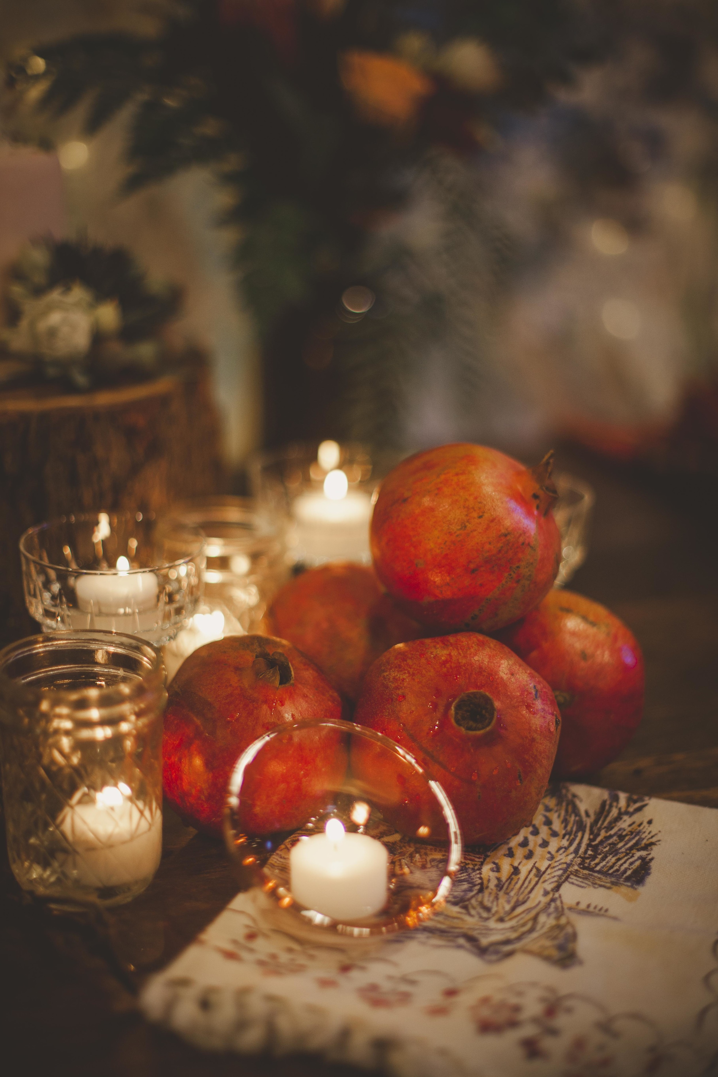 Christmas theme table set with candles and pomegranate 