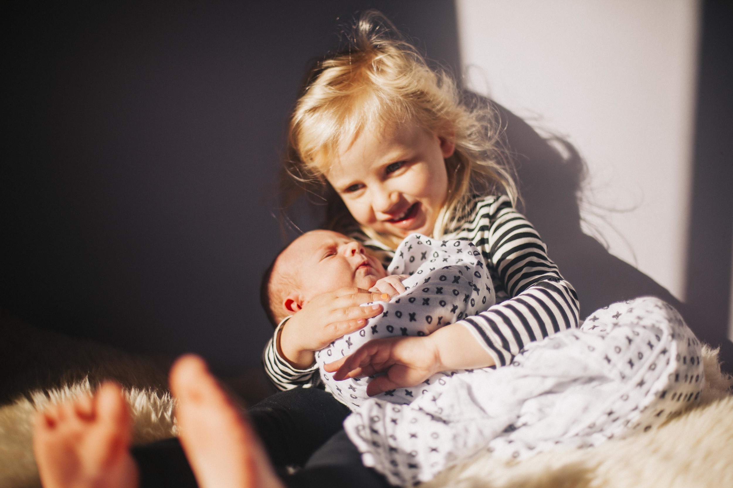 big sister holding little brother