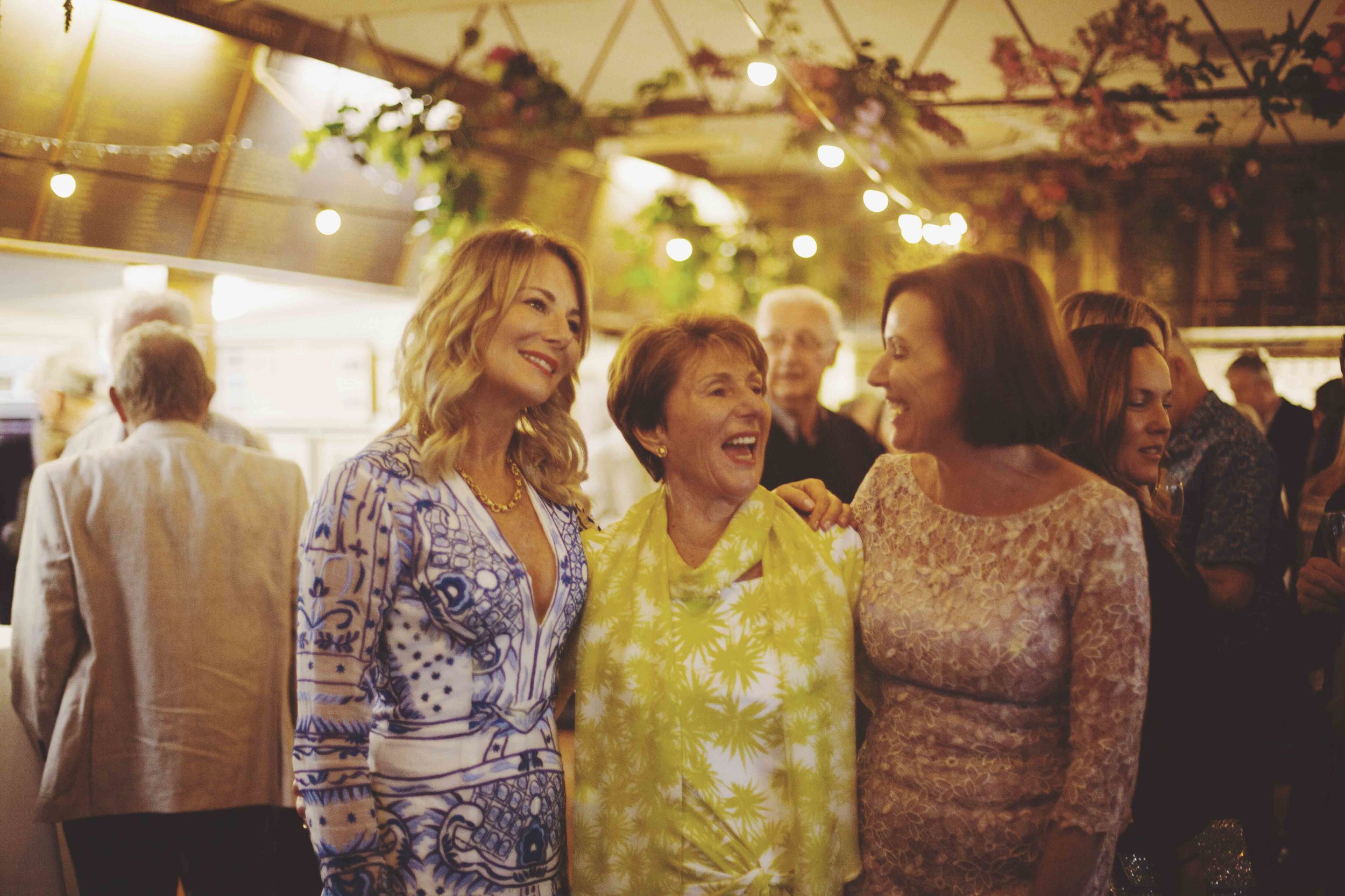 Group of women laughing at 80th birthday party