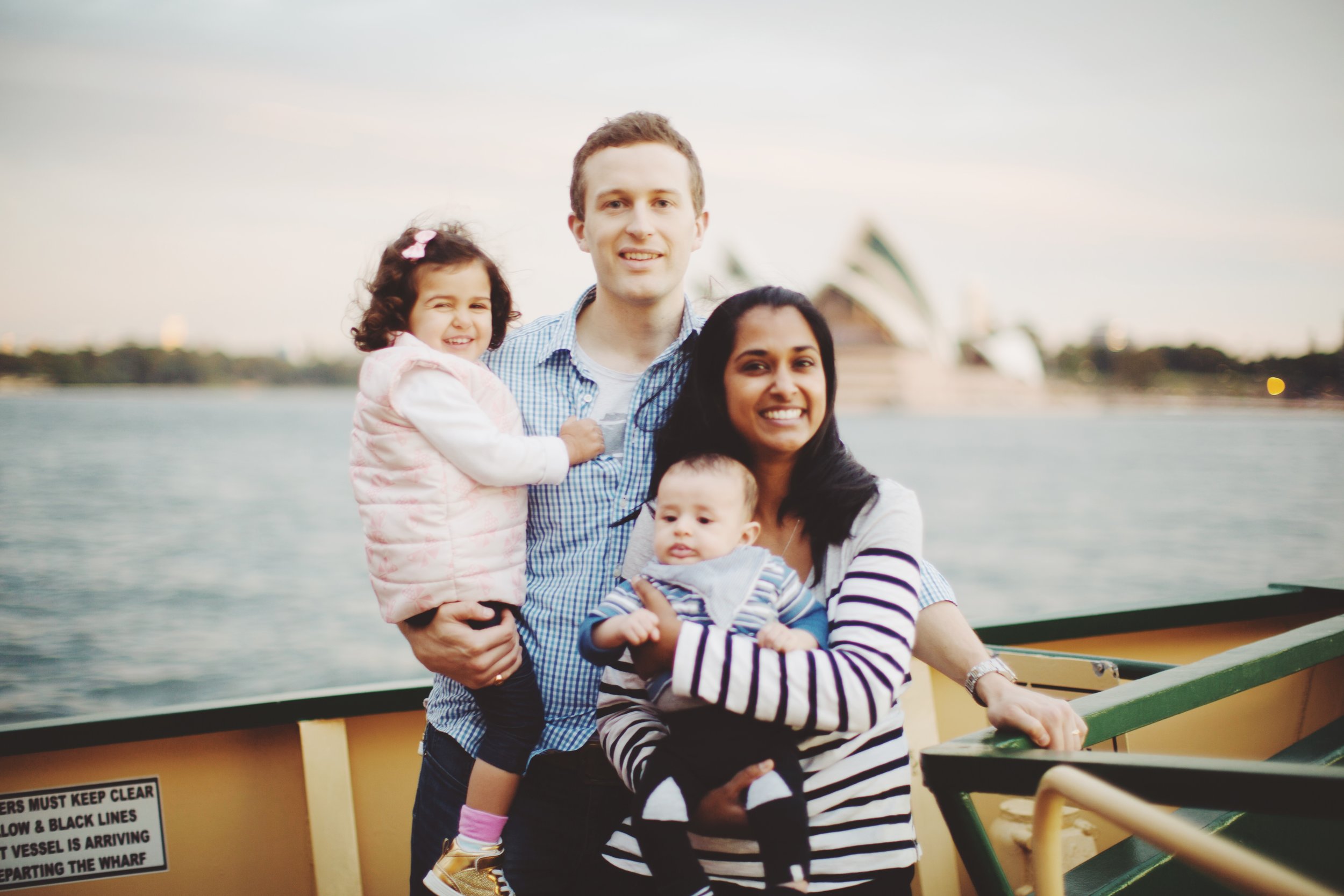 Family walking by harbour in Sydney