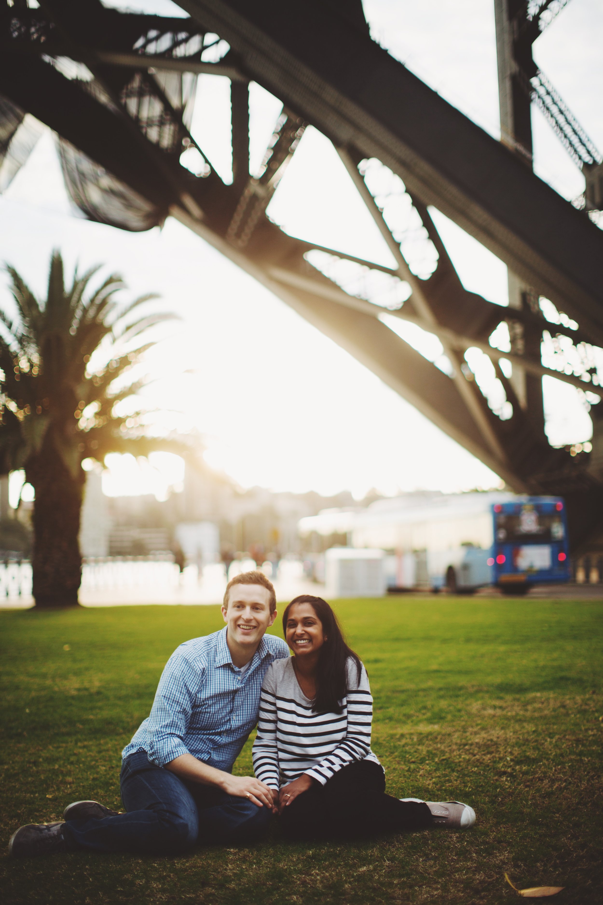 couple standing below Sydney Harbour Bridge