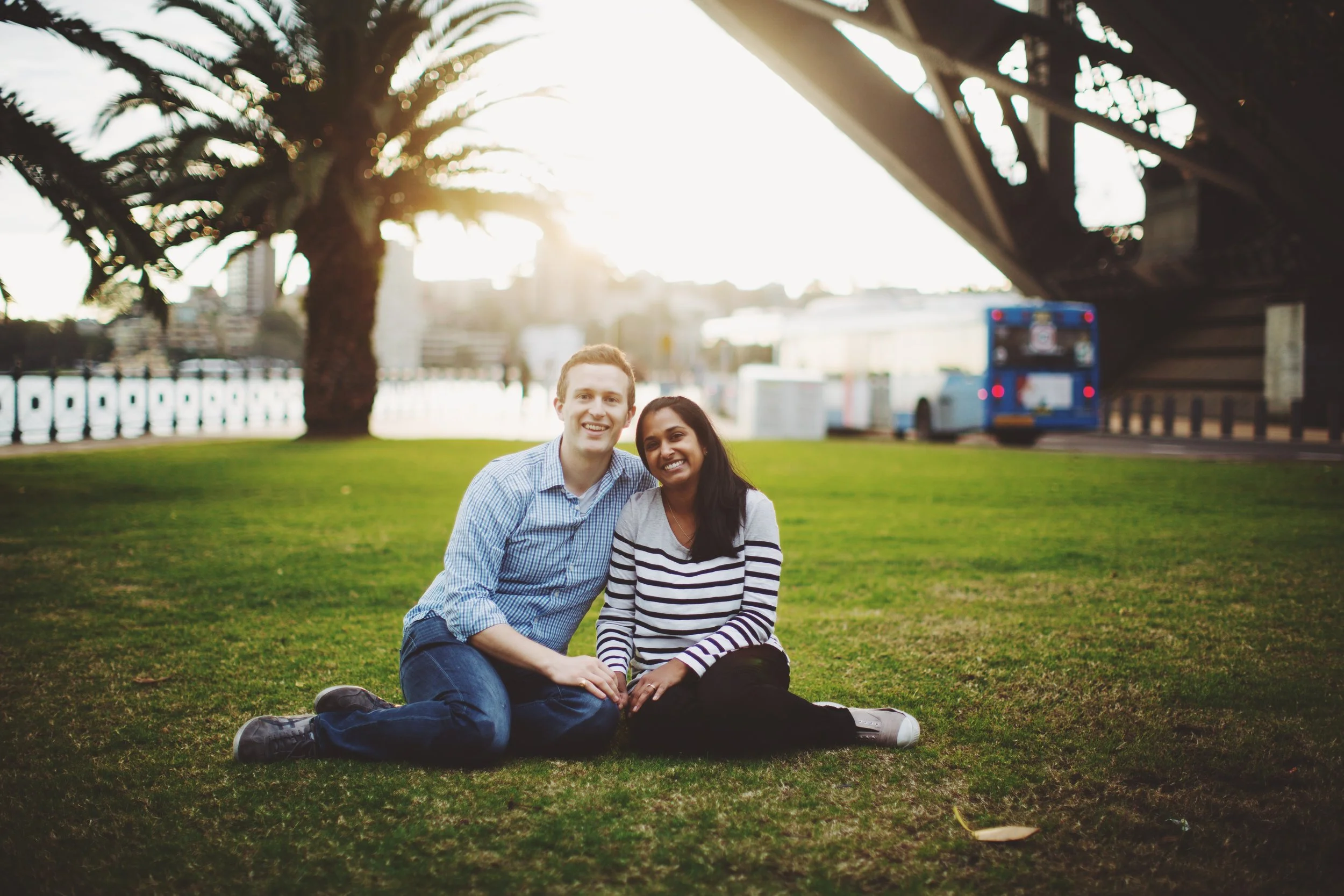 couple standing below Sydney Harbour Bridge