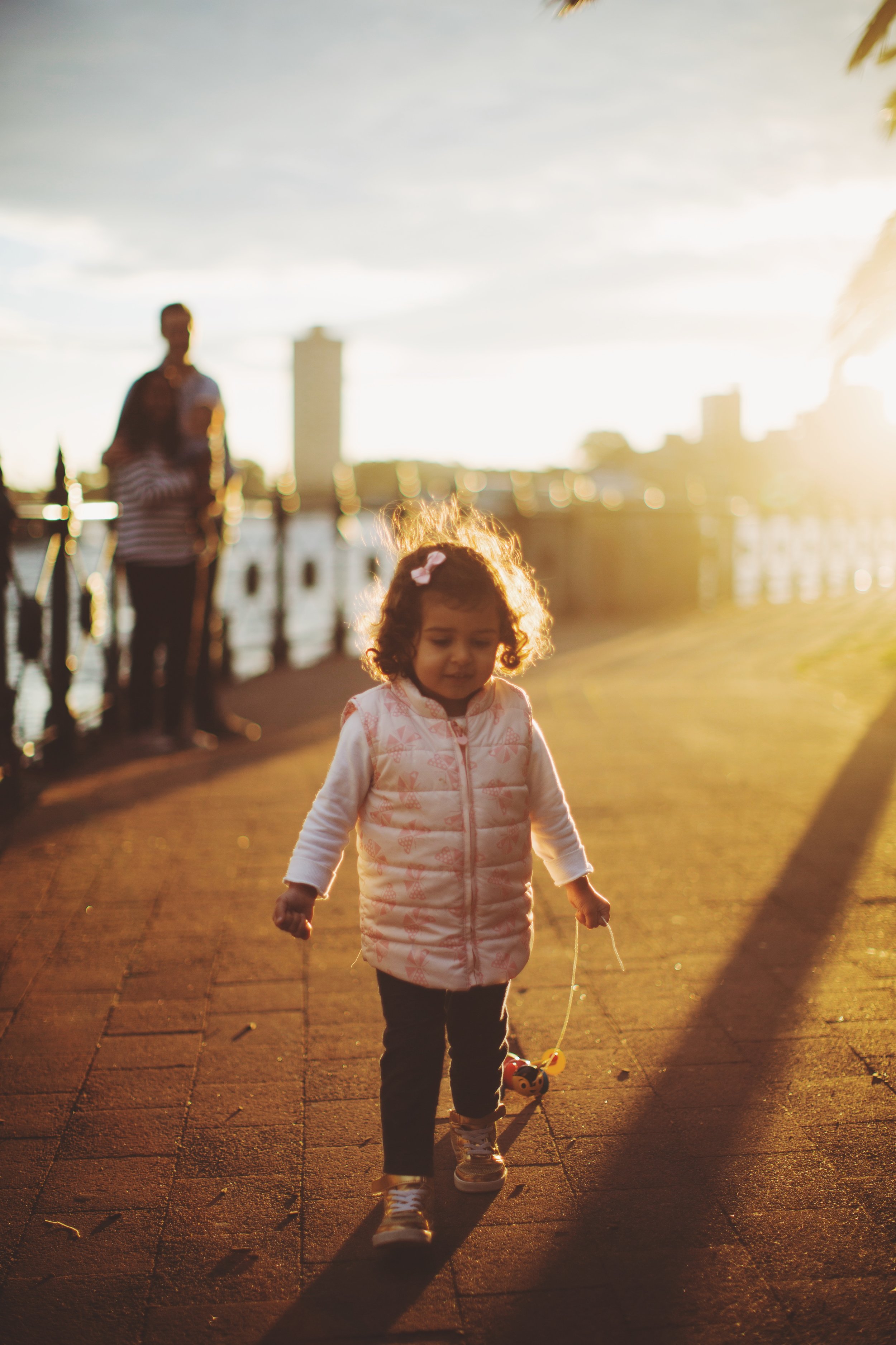 Young girl walking by harbour in Sydney