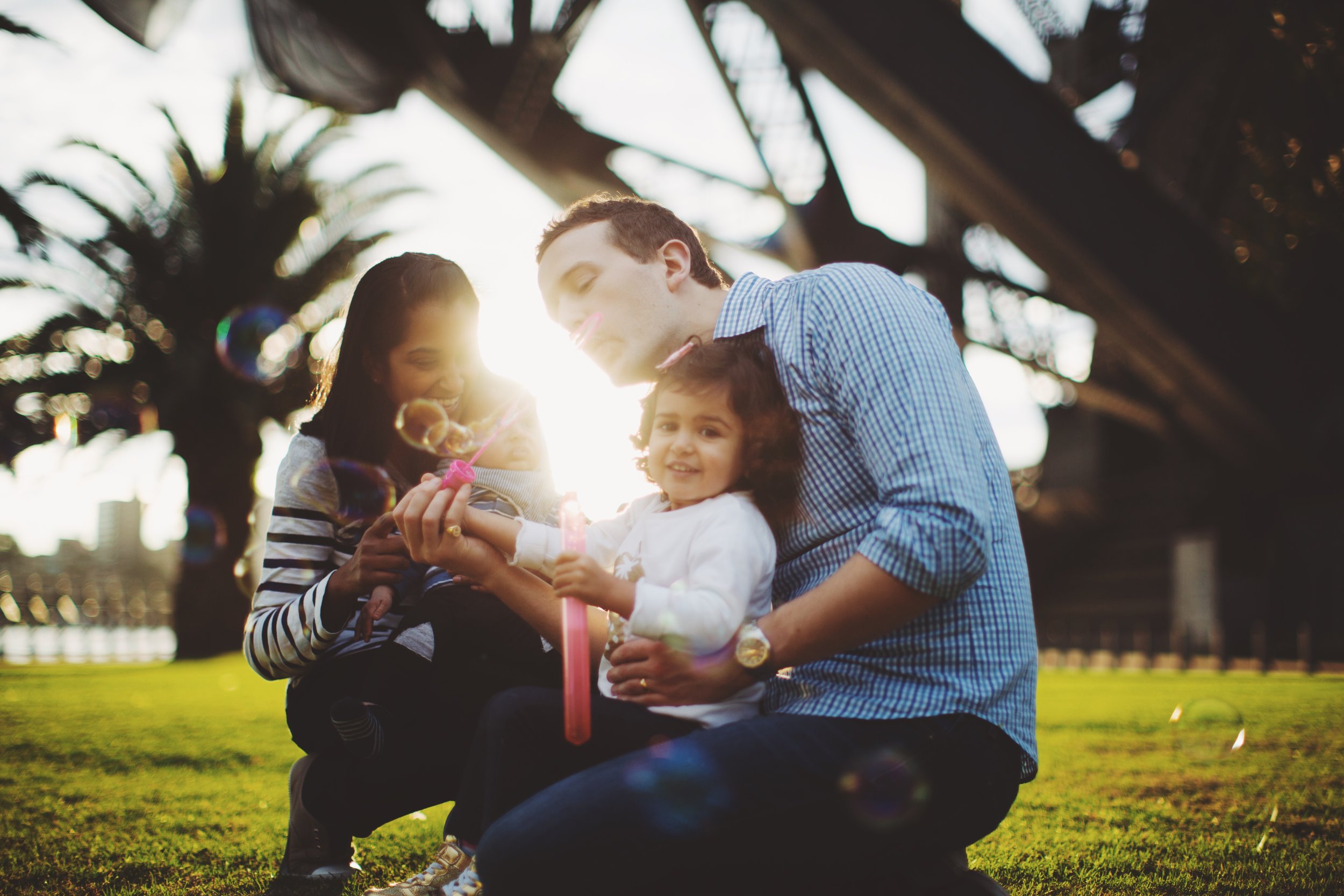 Family standing below Sydney Harbour Bridge