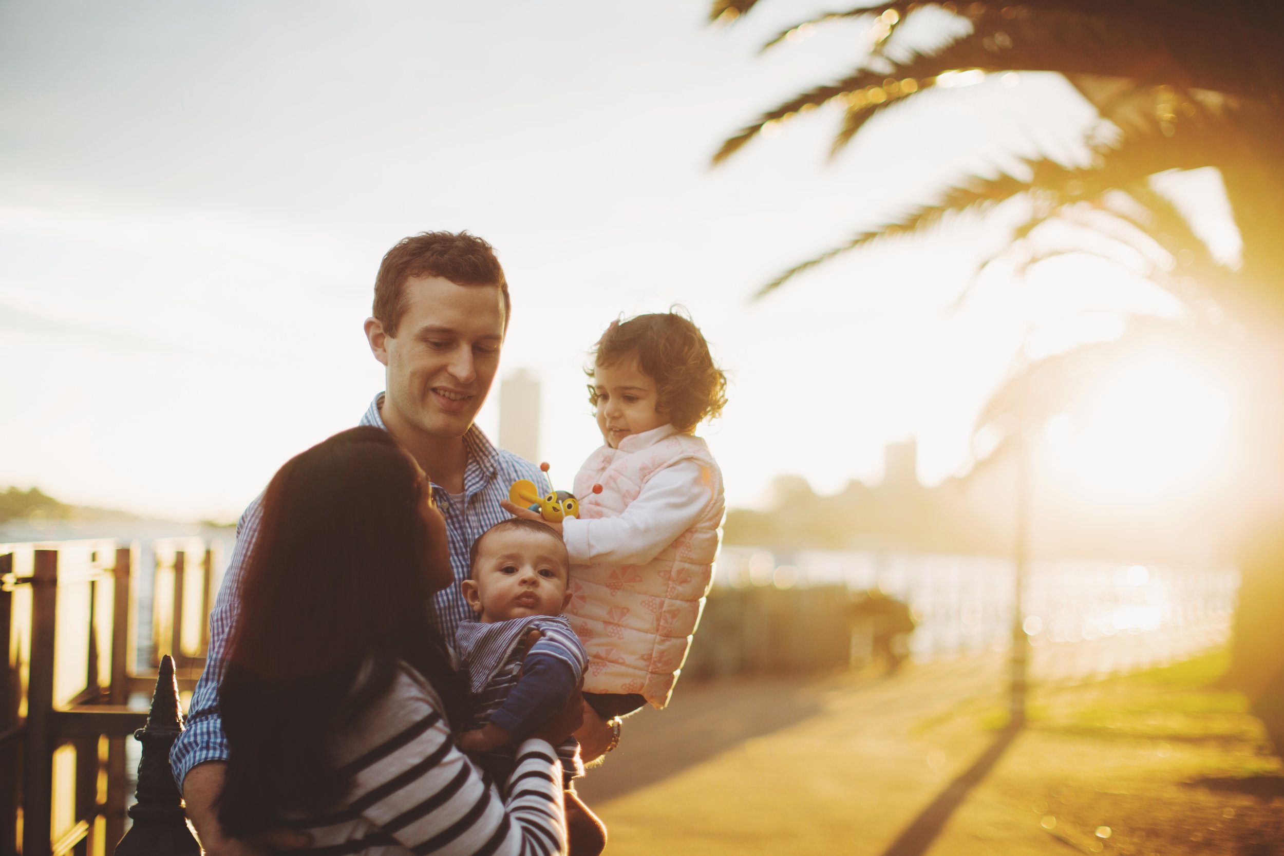 Family walking by harbour in Sydney