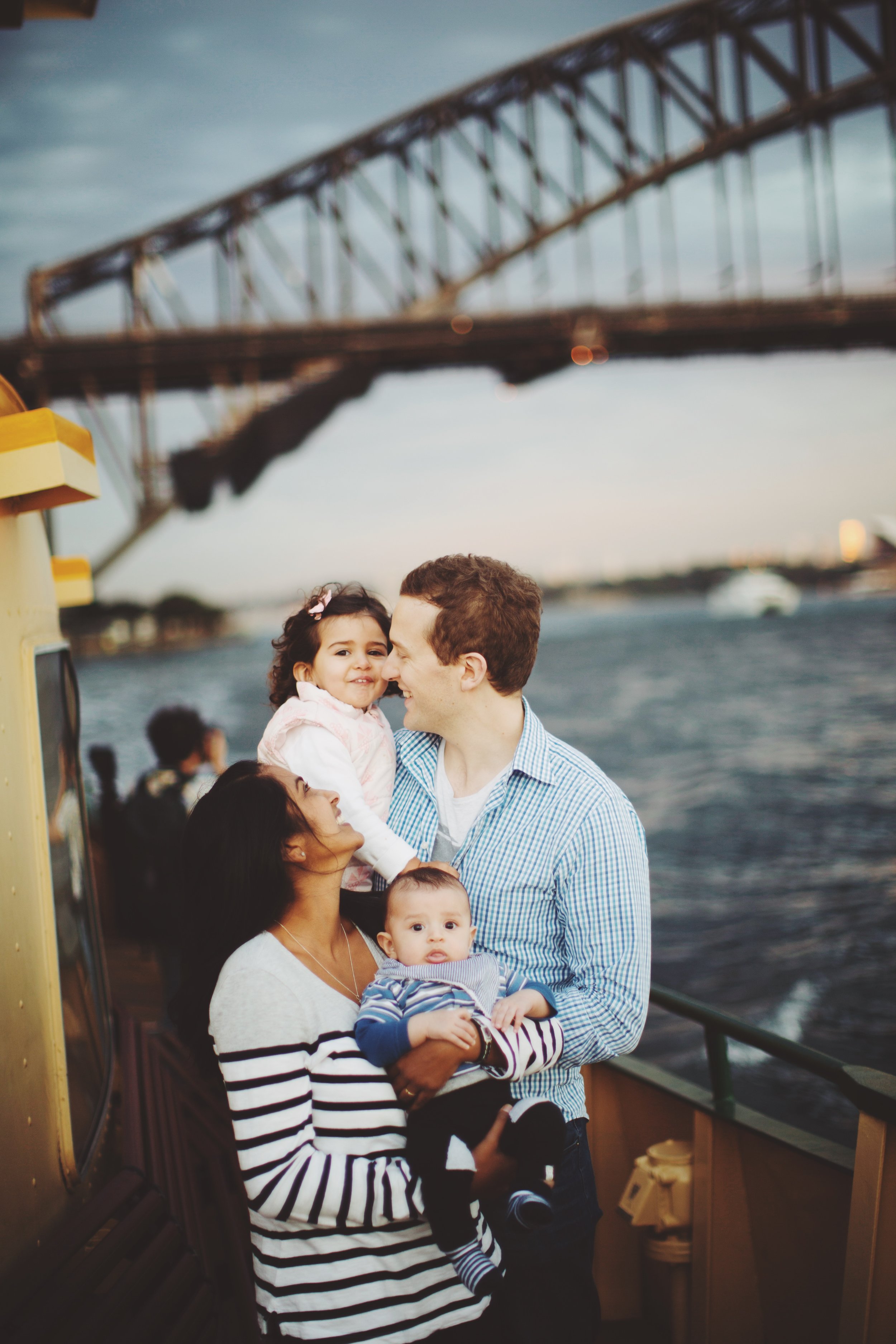 Family walking by harbour in Sydney