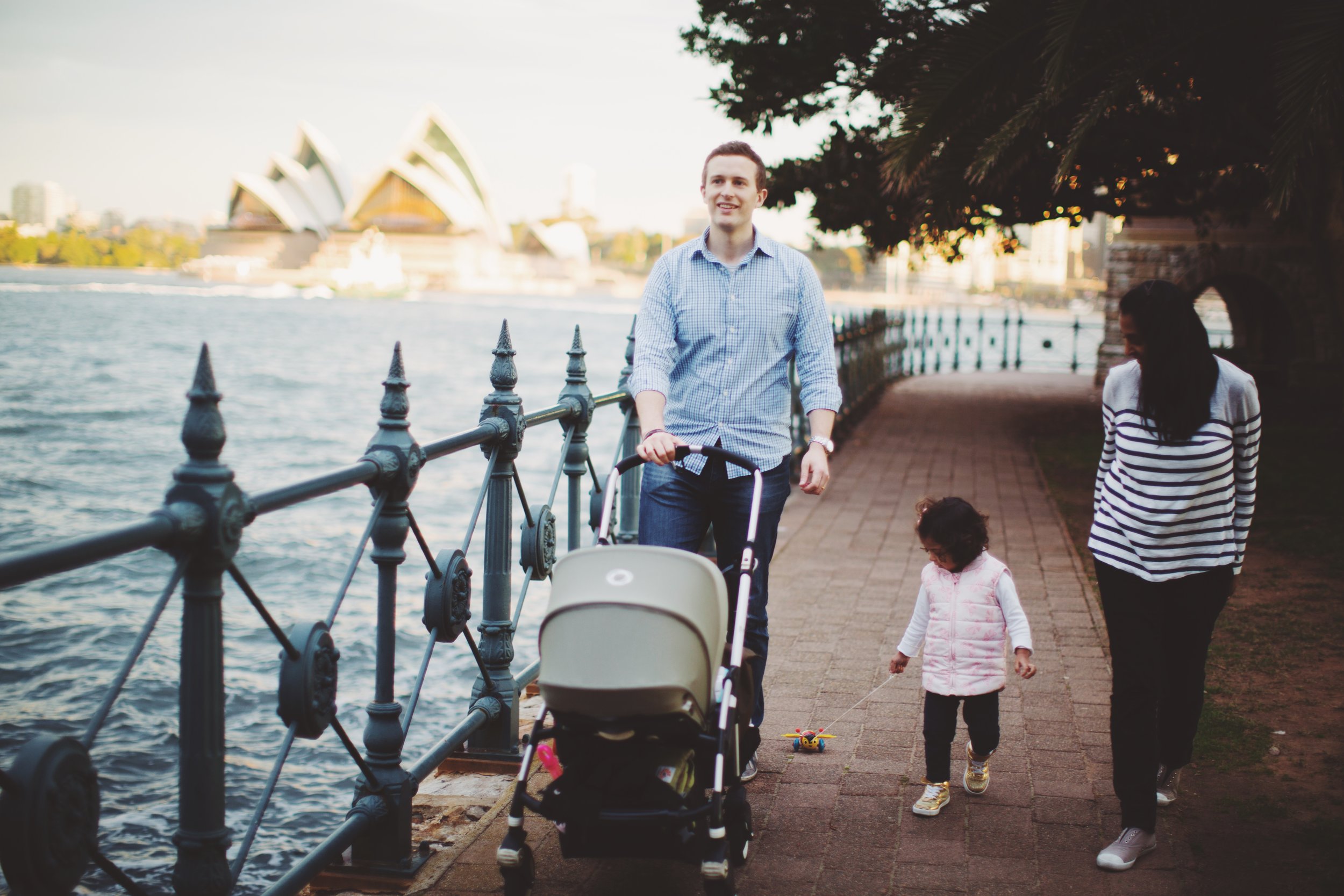 Family walking by harbour in Sydney