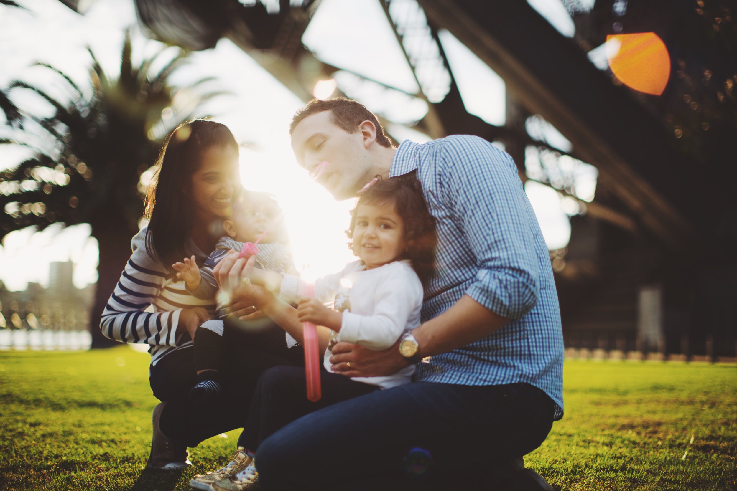 Family standing below Sydney Harbour Bridge